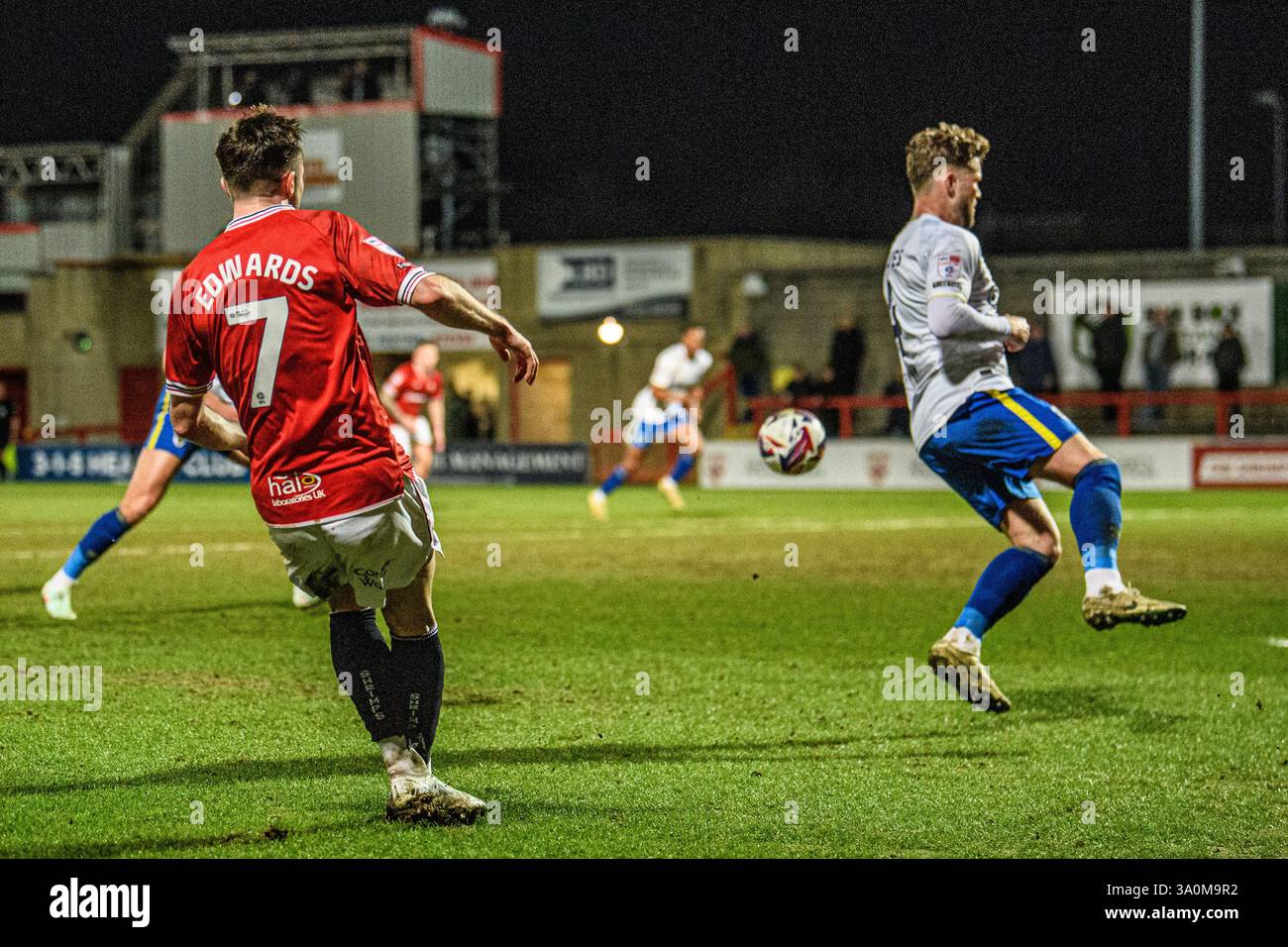 Jake Reeves of AFC Wimbledon tries to block the shot by Morecambe FC's ...