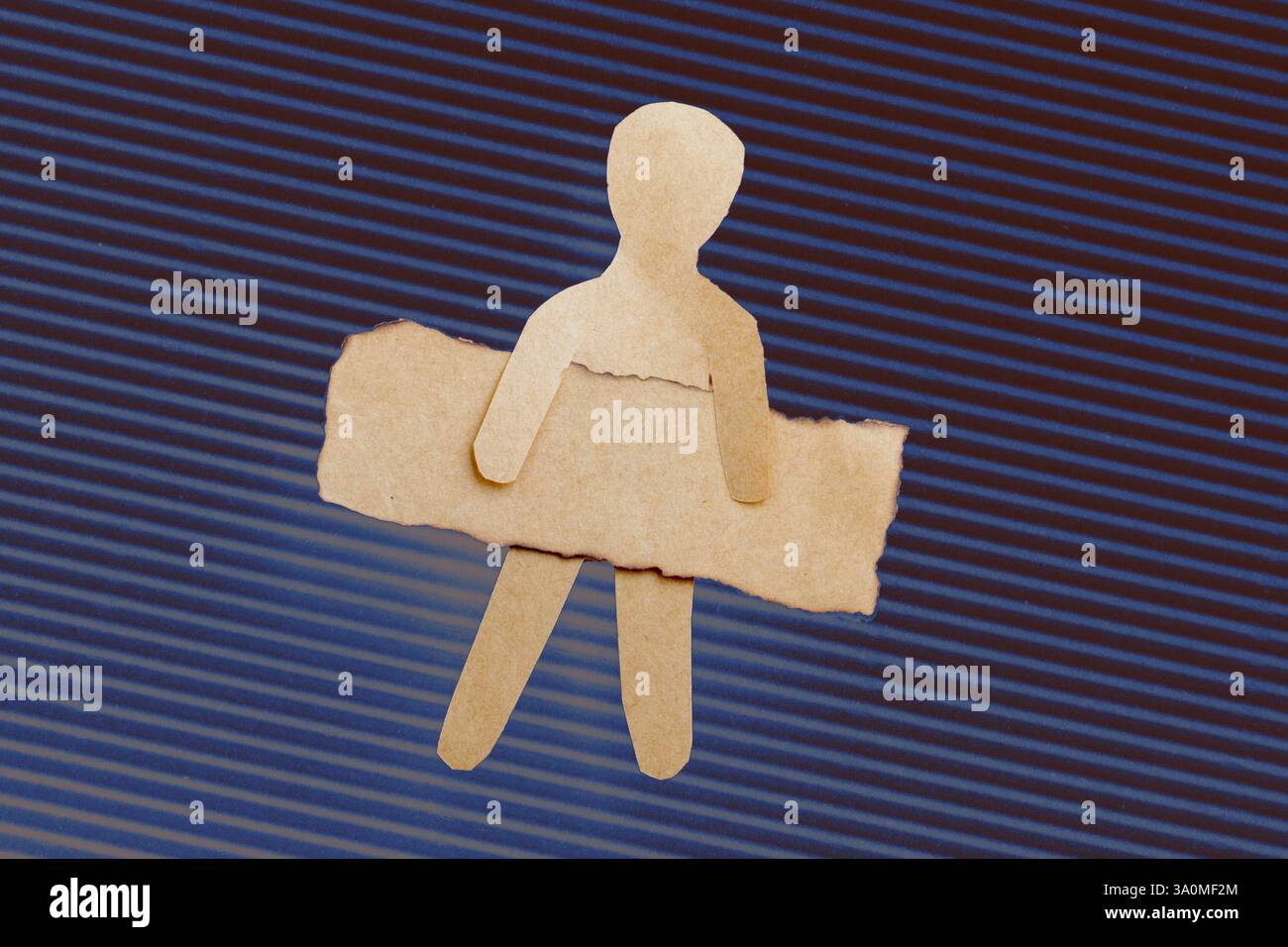 Paper man shape holding burnt note paper in hand Stock Photo