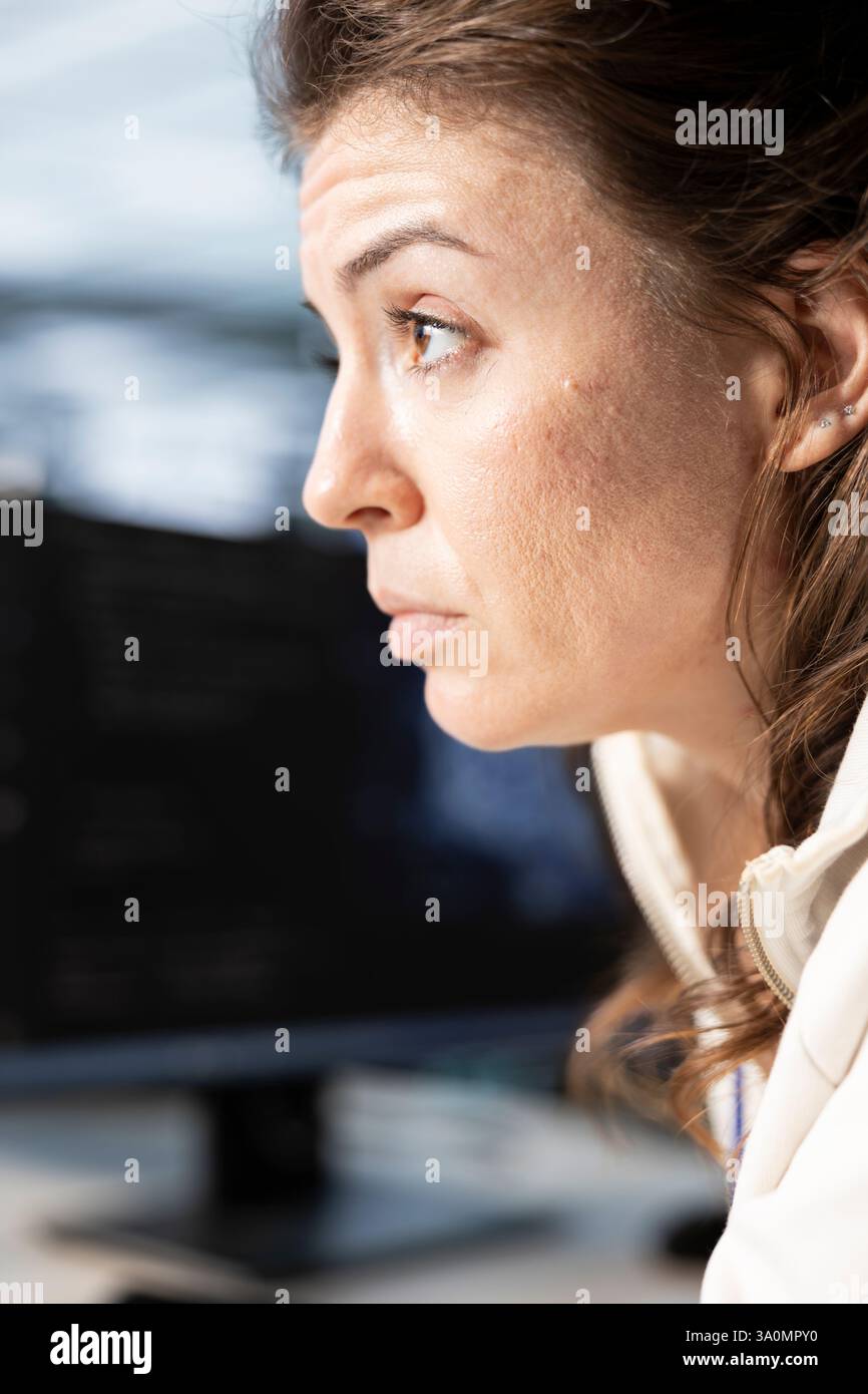 Technician in data center workplace coordinating deployment of server architecture, improving data processing speed. Worker in server farm configuring and testing equipment, close up Stock Photo