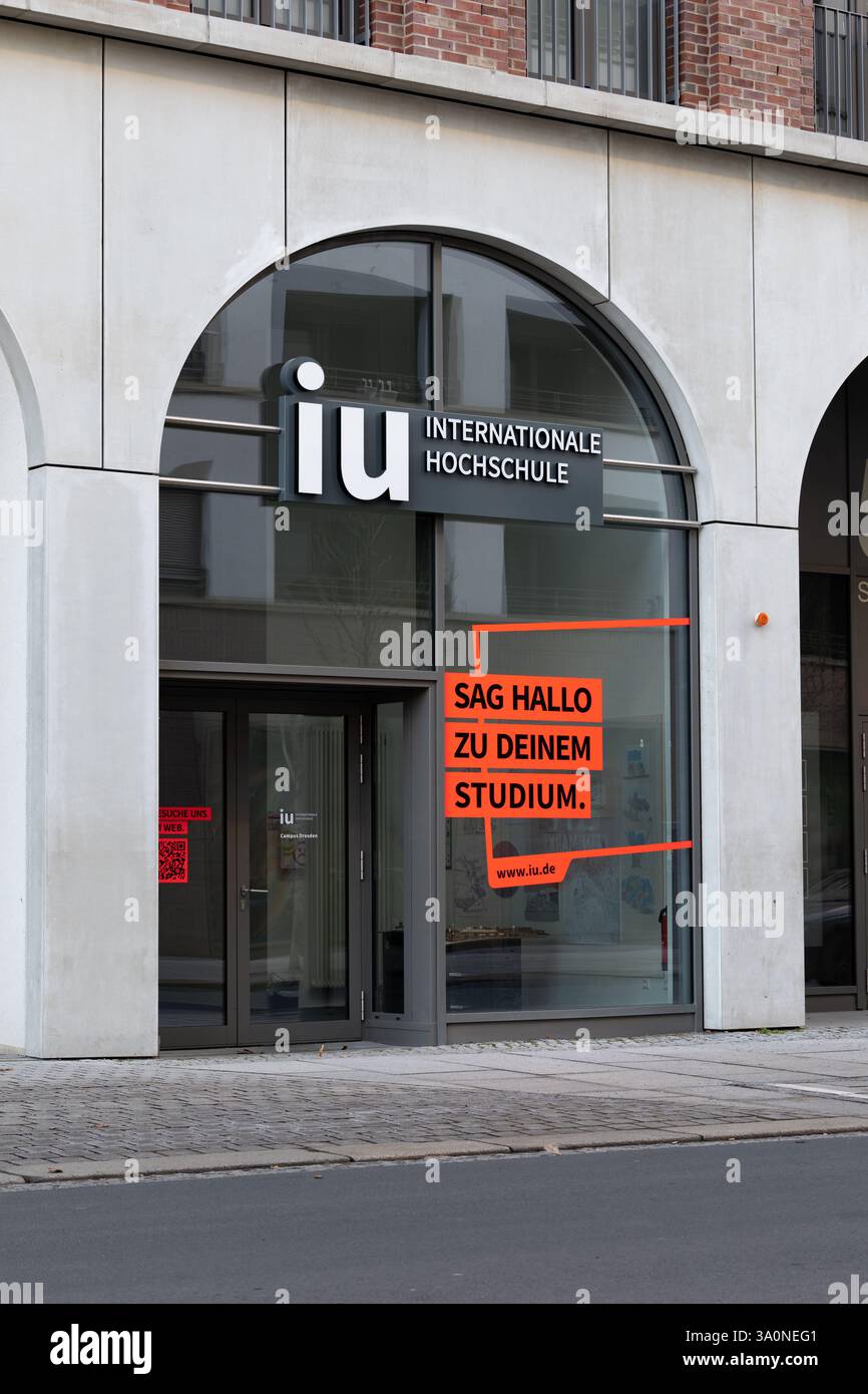 IU Internationale Hochschule logo sign on the campus building facade in Dresden. International university of applied sciences in Dresden city. Stock Photo
