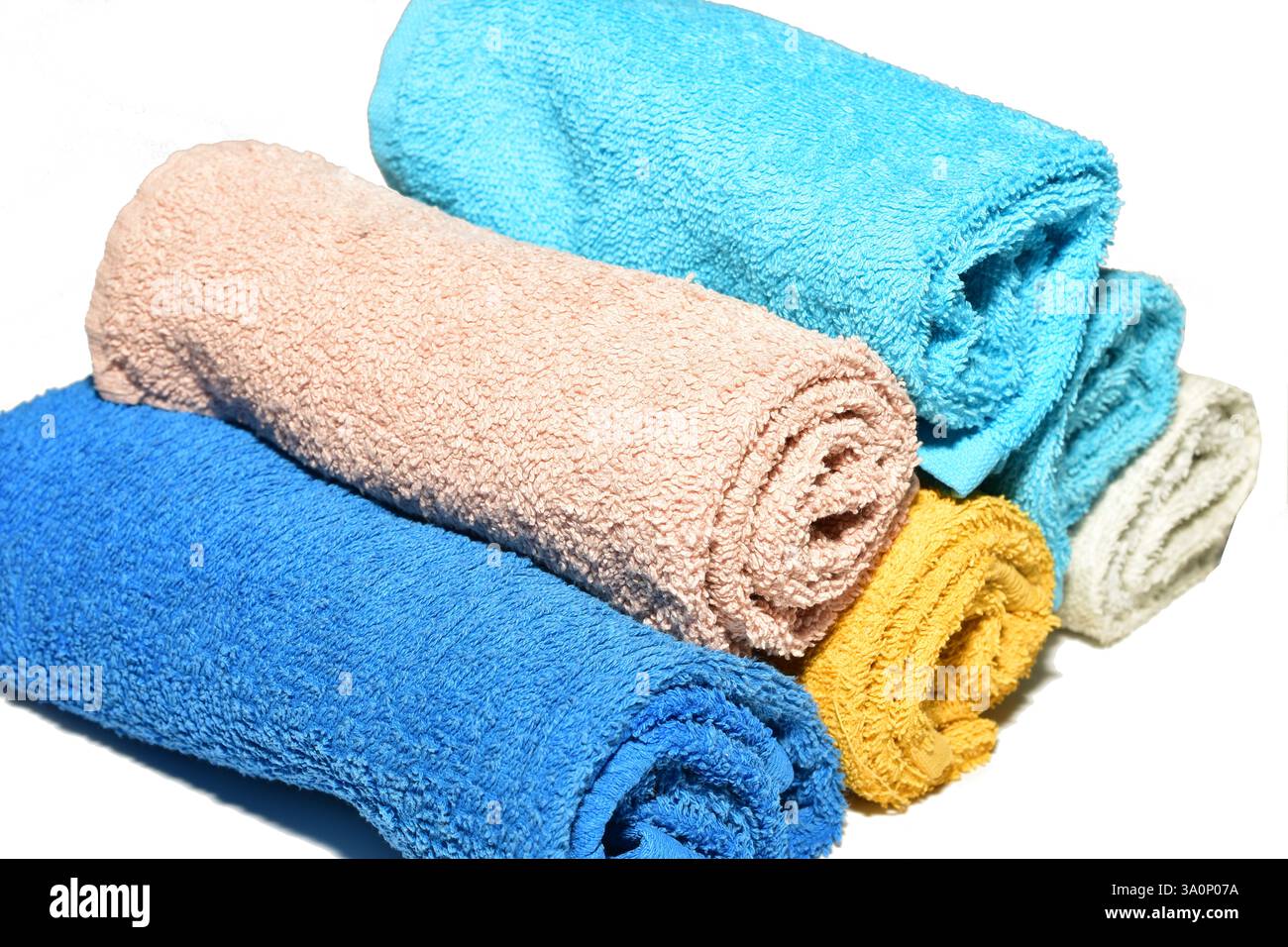 Terry short hand towels lie in a stack on a white background. Side view. Stock Photo