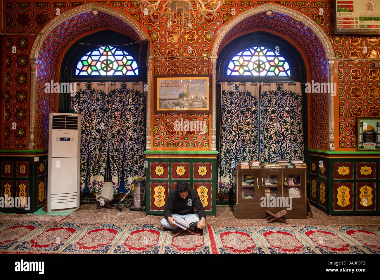 A Kashmiri Muslim man recites the Islamic Holy Book Quran inside the ...