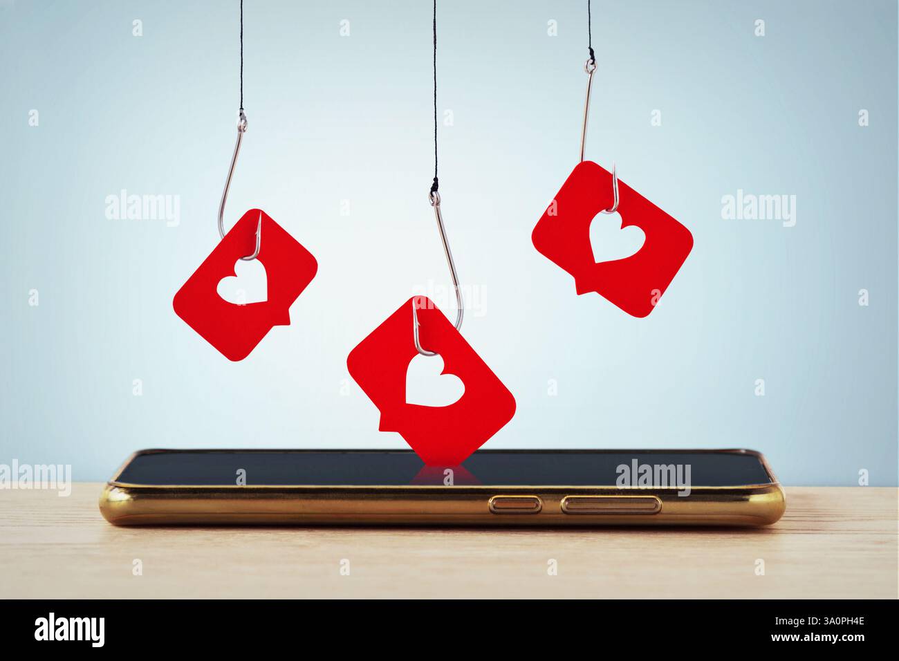 Mobile phone and fishing hooks with social media like buttons - Concept of social media, popularity and marketing strategy Stock Photo