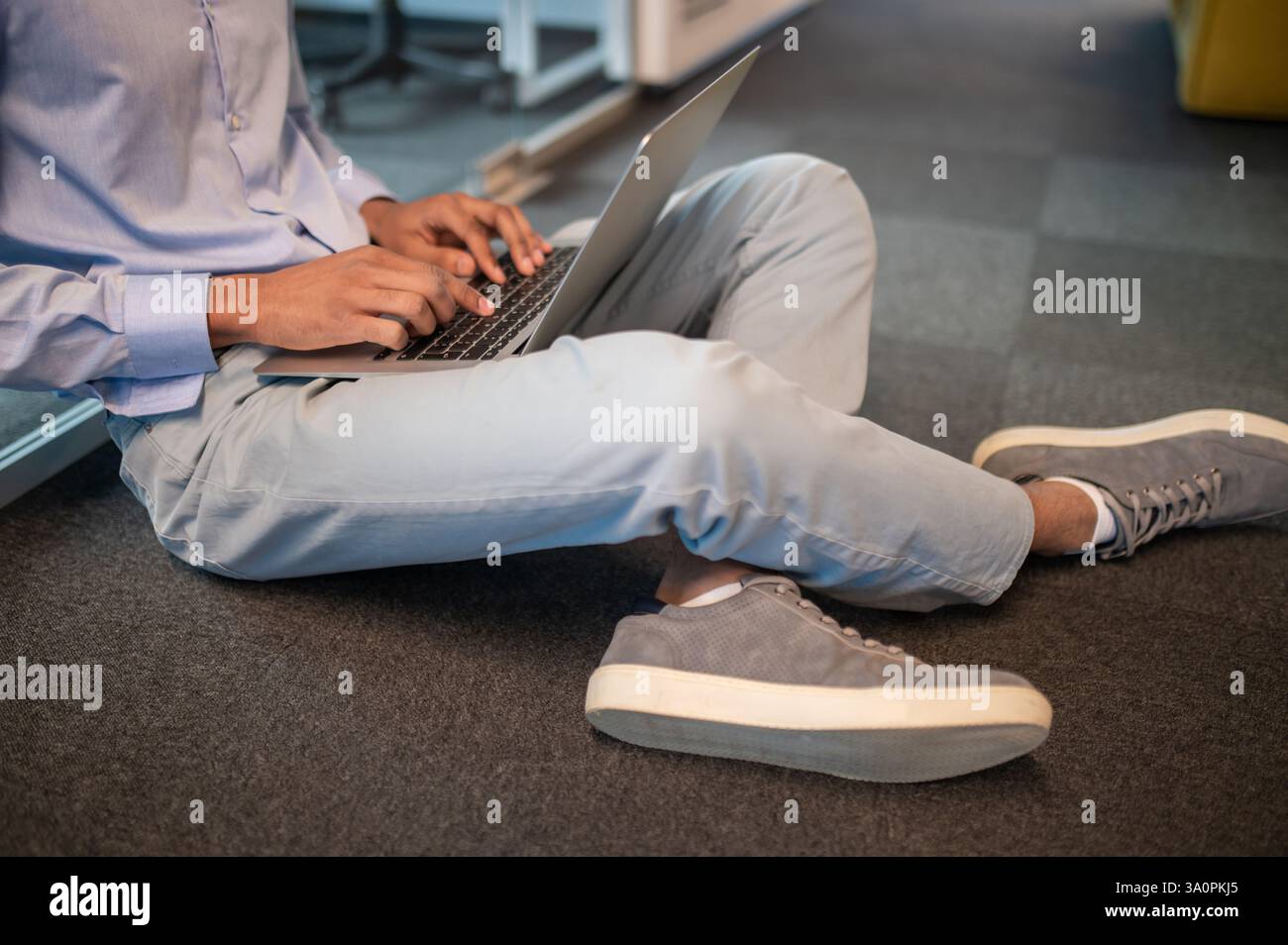 Unrecognizable male student freelancer using computer for working Stock Photo