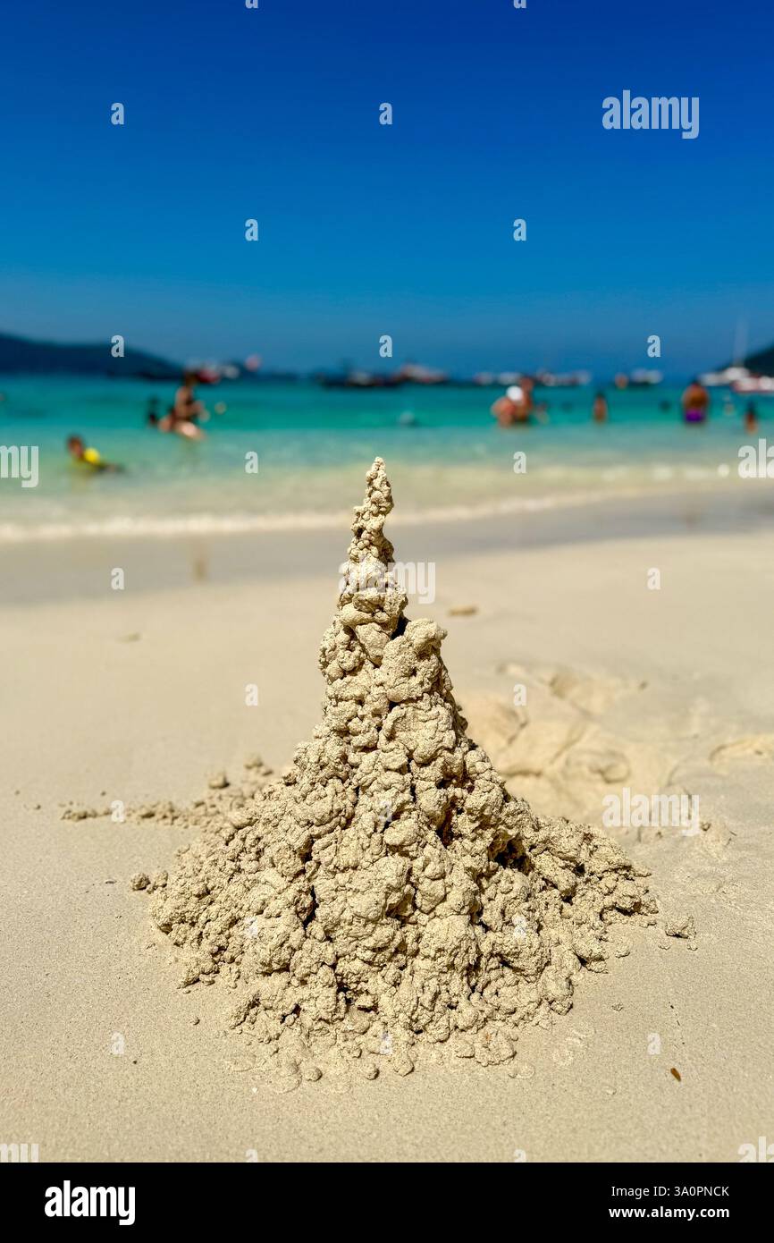 Artistic Sandcastle on a Sunny Beach 3 A naturally sculpted sandcastle rises from the sun-kissed beach, showcasing its intricate and organic texture. - Smartphone Captured Stock Image