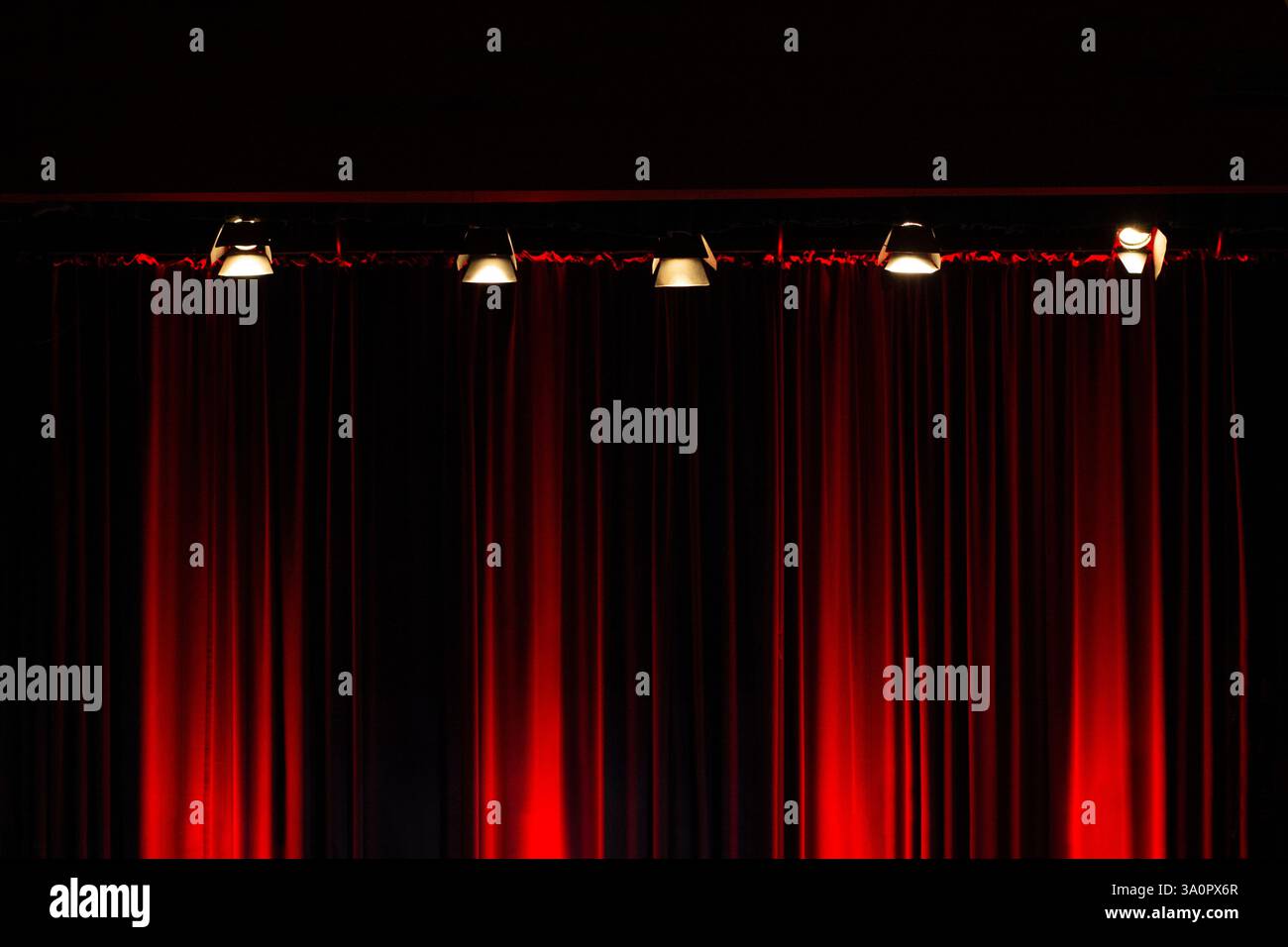 Stage lights on red velvet theater curtain Stock Photo - Alamy