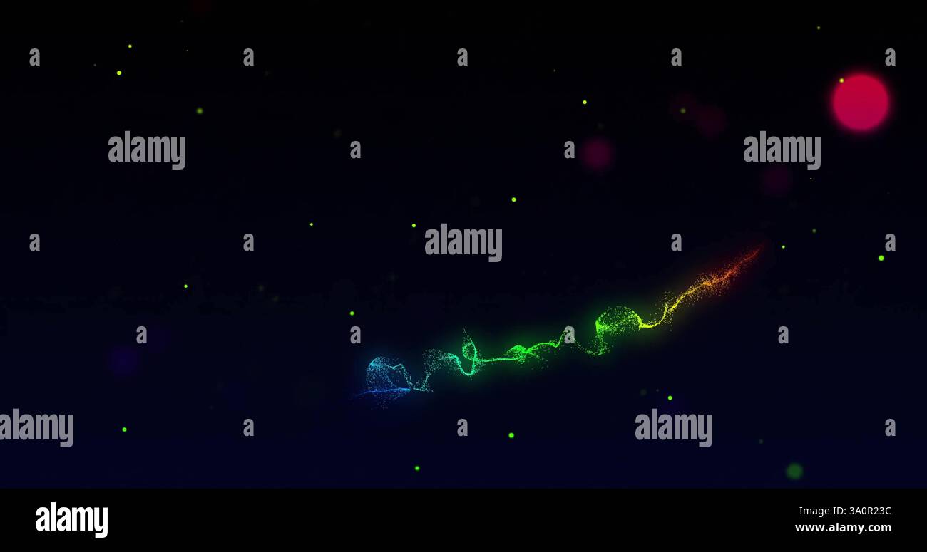 Colorful light trails and particles image over dark background Stock Photo