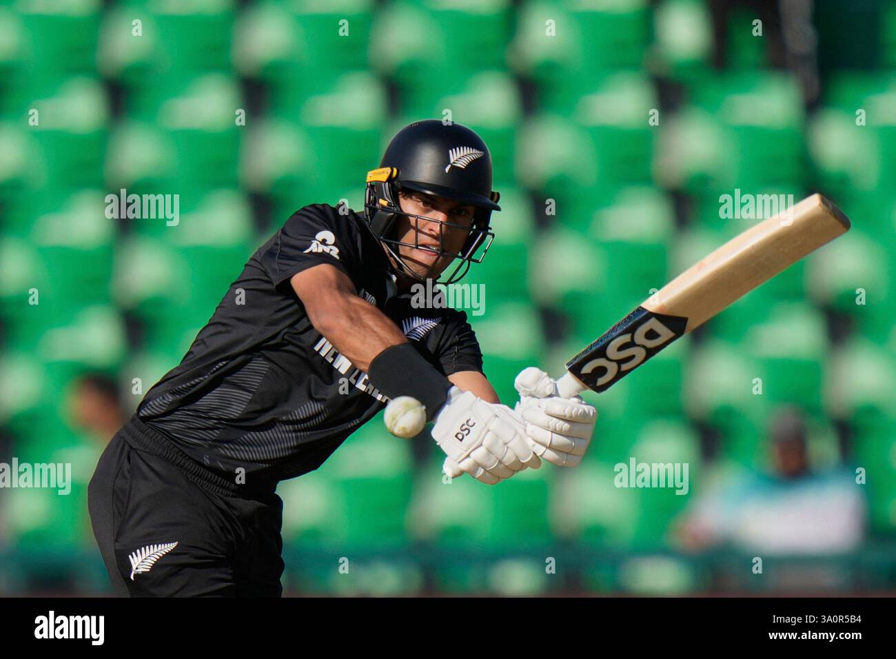 New Zealand's Rachin Ravindra plays a shot during the ICC Champions ...