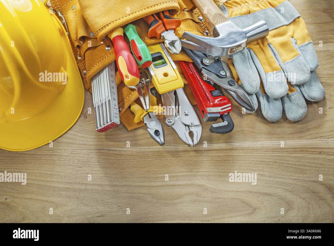 Construction tooling tool belt protective gloves hard hat Stock Photo
