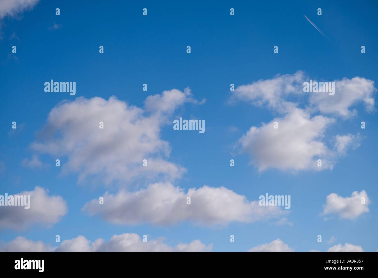 Blue 'Simpsons Sky' - clear blue sky with white fluffy clouds Stock Photo