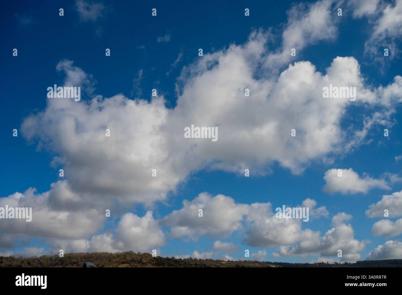 Blue 'Simpsons Sky' - clear blue sky with white fluffy clouds Stock Photo