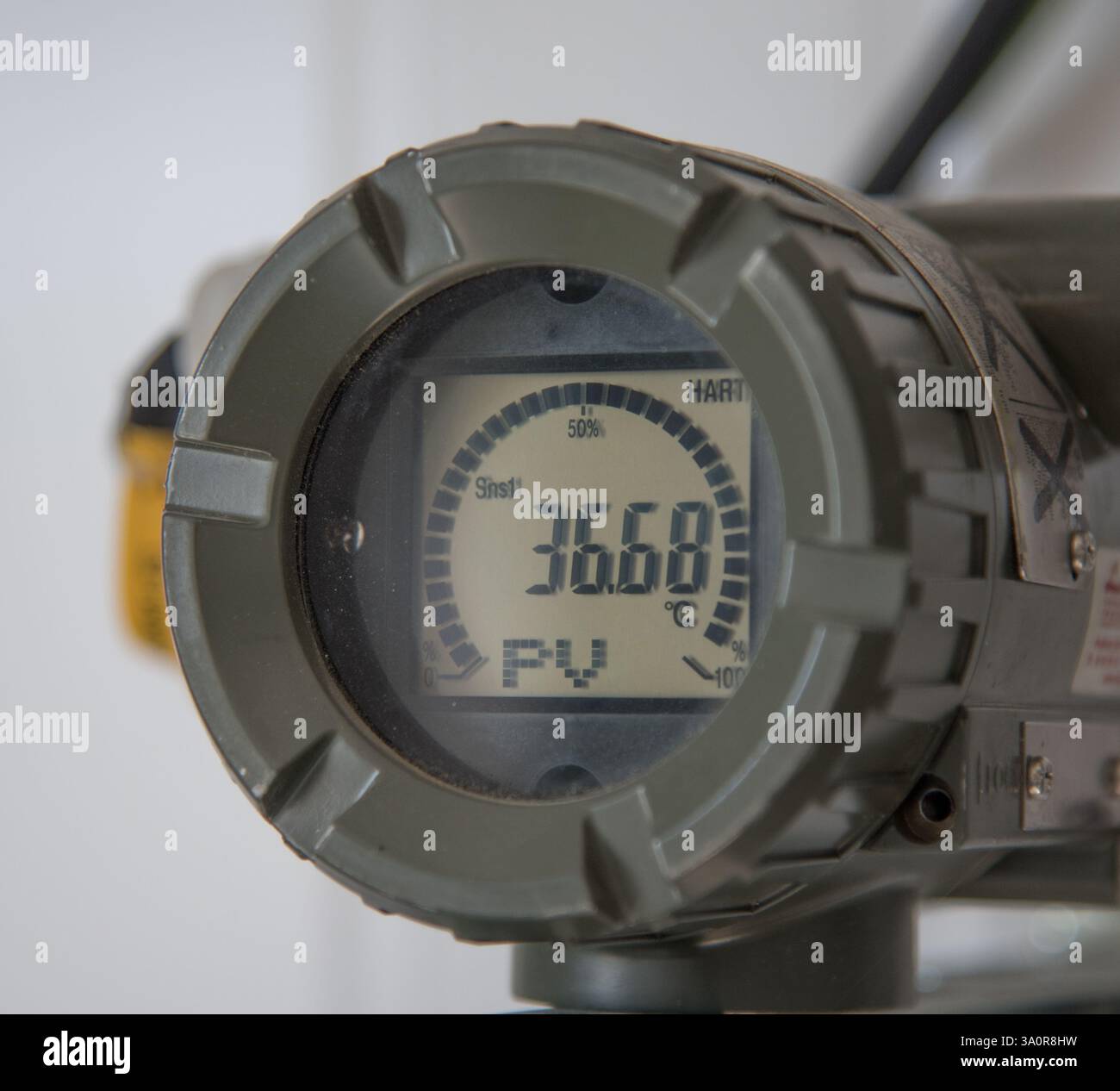 The photo shows an industrial device with a digital display. The display shows the value 36.68 and the designation PV. Stock Photo