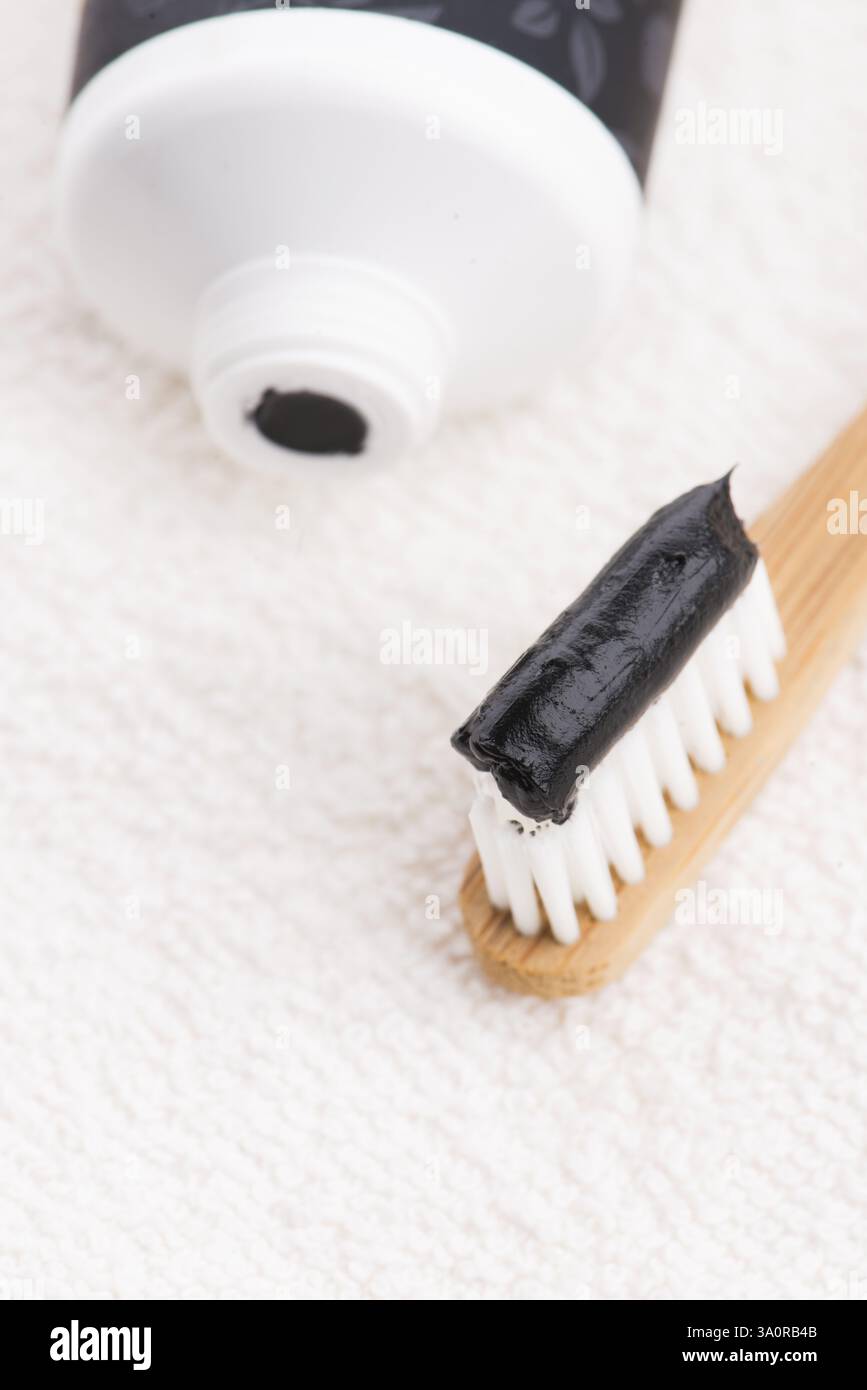 Toothbrush with black charcoal toothpaste Stock Photo - Alamy