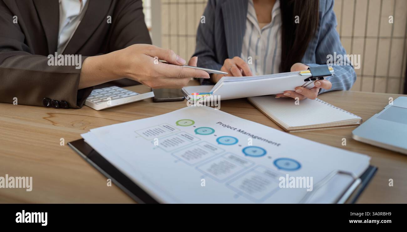 Project management discussion. Team members analyzing project details and collaborating effectively. Stock Photo