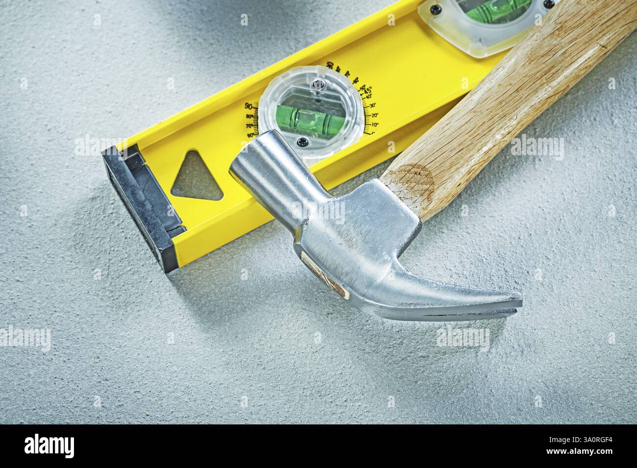 Claw hammer construction level on concrete background building concept ...