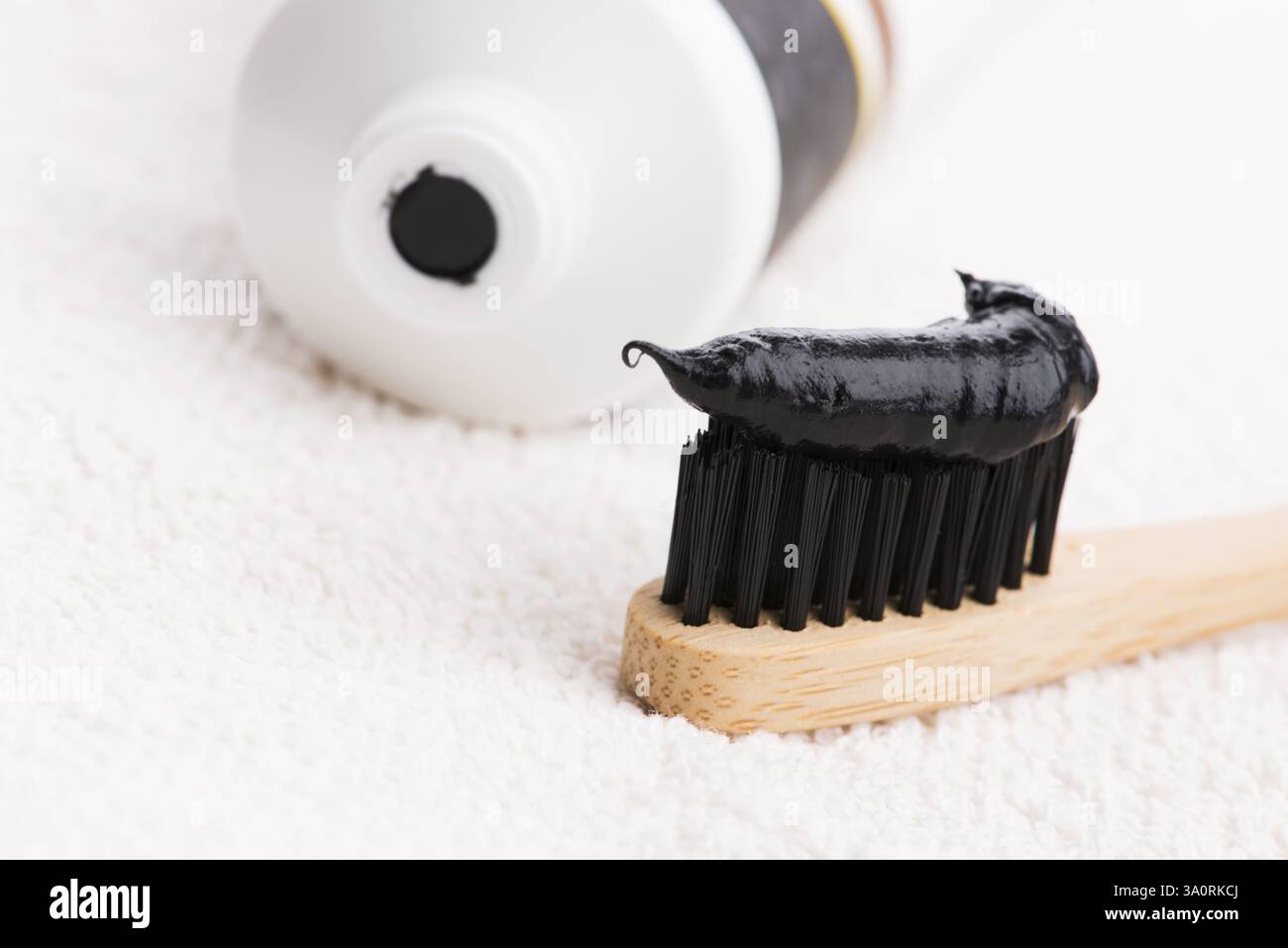 Toothbrush with black charcoal toothpaste Stock Photo