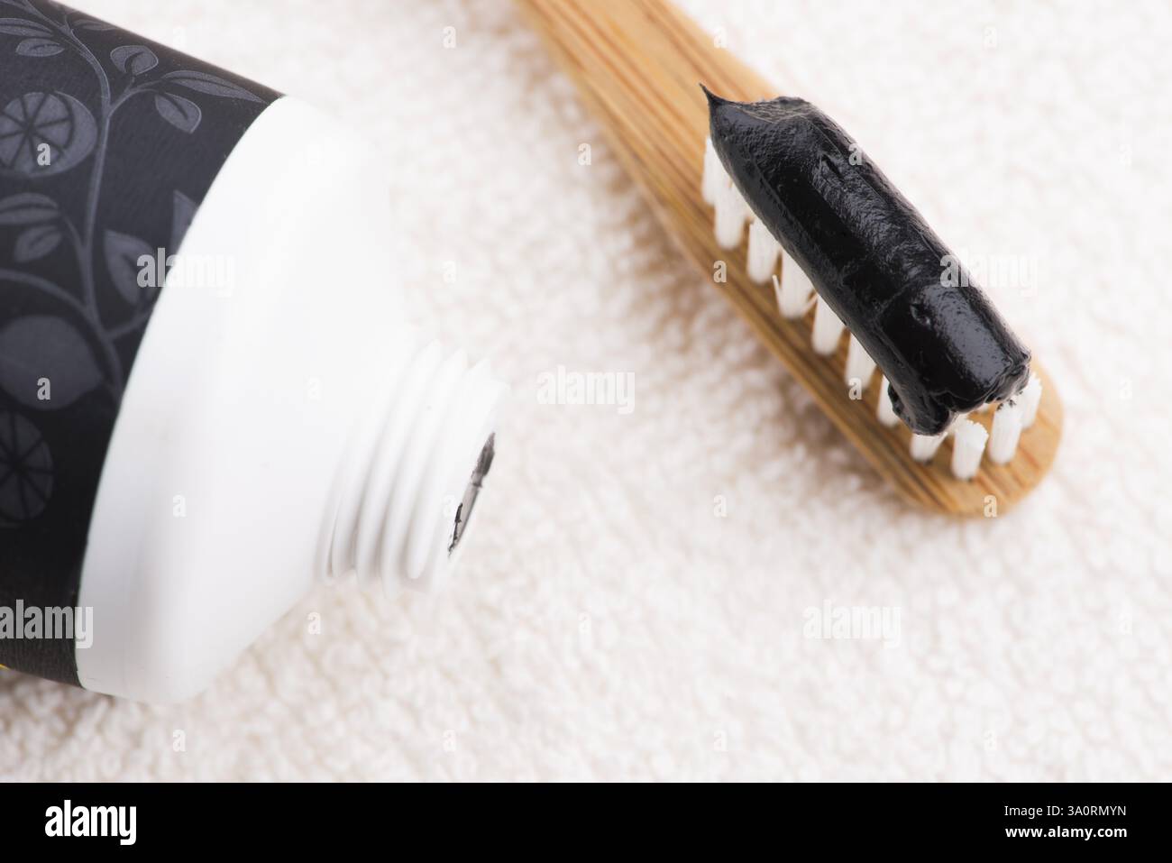 Toothbrush with black charcoal toothpaste Stock Photo