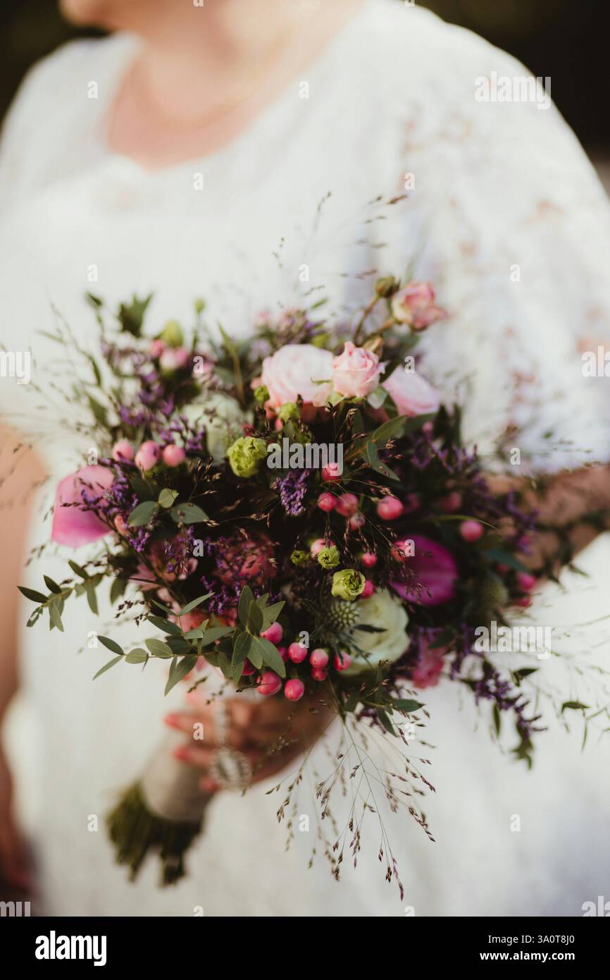 Beautiful bouquet of roses in the bride's hand Stock Photo