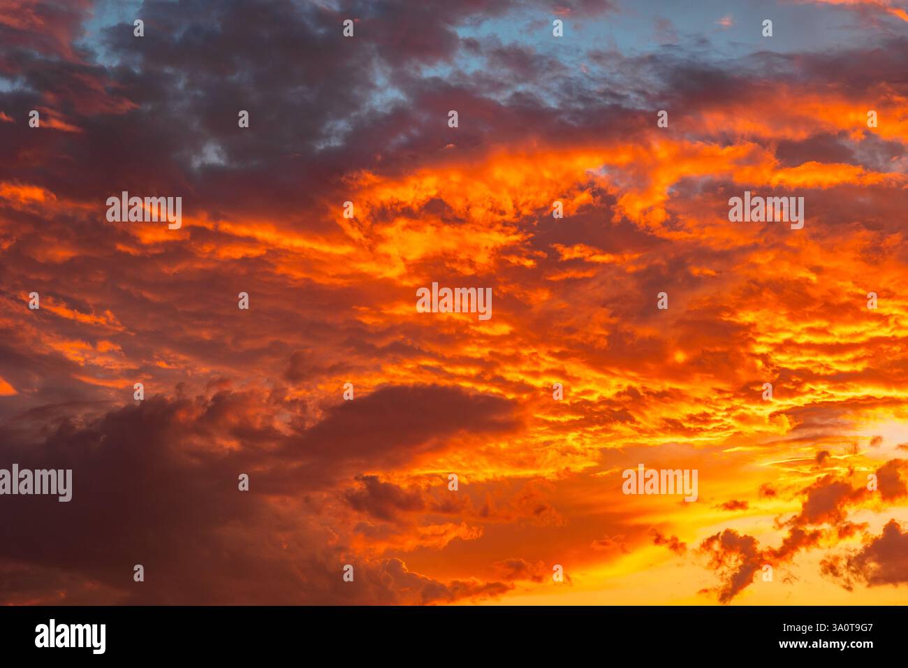 Dramatic orange clouds. Dramatic sunset background photo. Cloudscape with orange clouds. Stock Photo