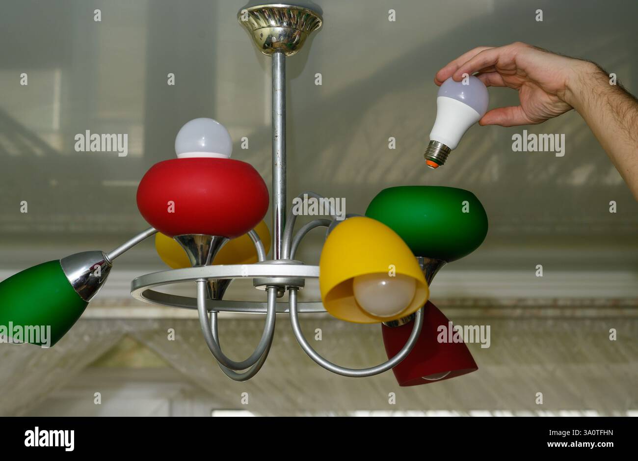 replacing an LED one. concept  Stock Photo