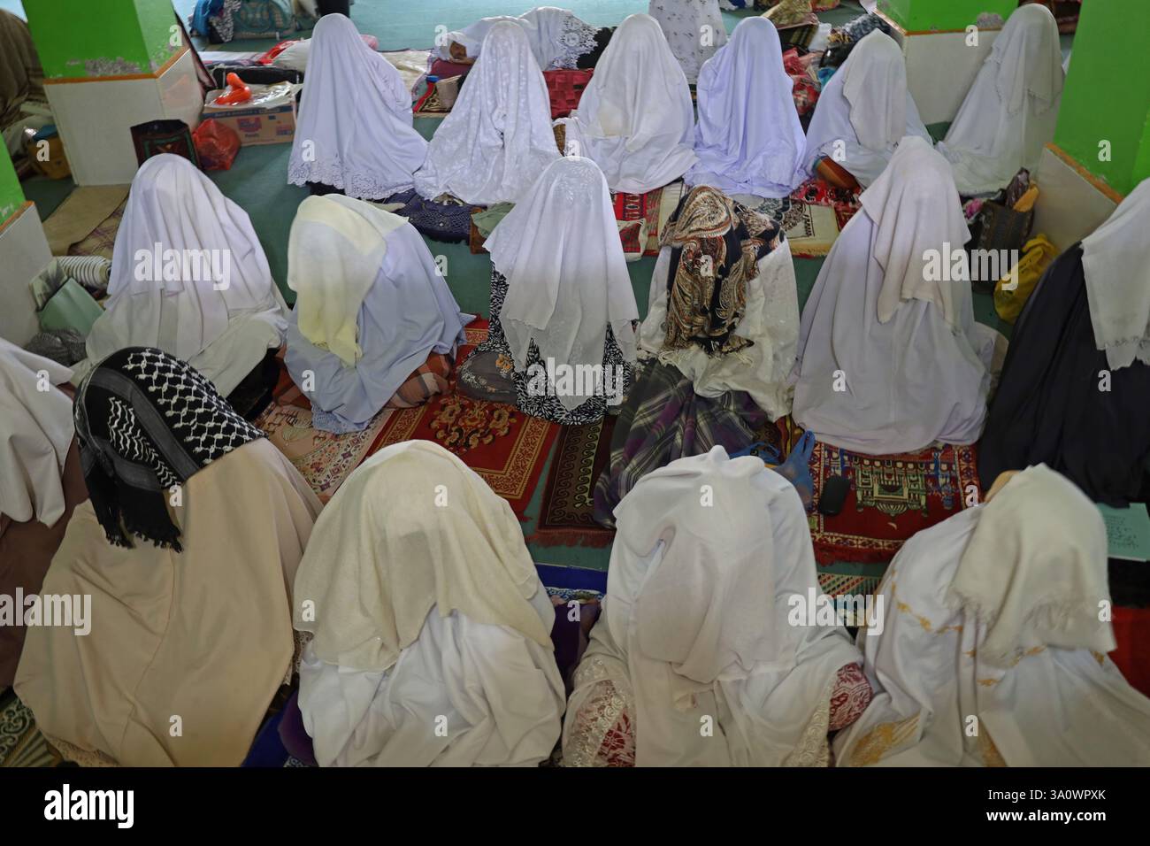Aceh Besar, Aceh, Indonesia. 5th Mar, 2025. Muslims cover their heads with cloth while attending suluk worship in Dayah Darul Aman, Lampuuk Village, Aceh Besar regency, Aceh province, Indonesia on Wednesday, March 05, 2025. Suluk spiritual activities for Muslims in Aceh have become a tradition in the month of Ramadan which is followed by male and female pilgrims with dhikr, sunnah prayers, and other worship that aims to purify the heart, purify the soul and get closer to Allah SWT. Credit: Khairu Syukrillah/ZUMA Press Wire/ZUMA Wire/Alamy Live News Stock Photo