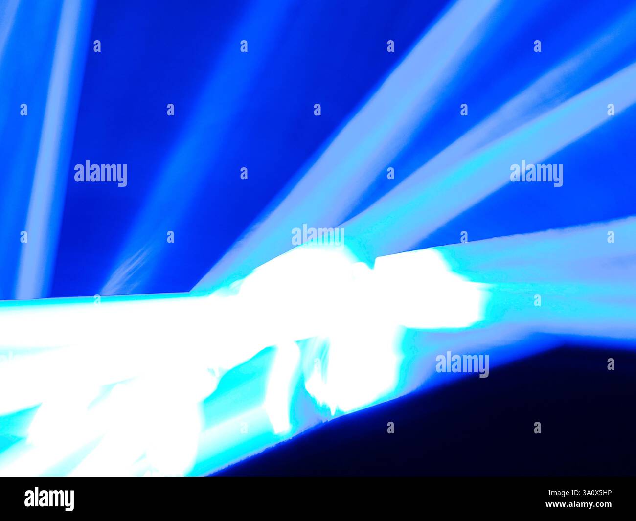 Abstract picture of white and blue streaks of light against a blue ...