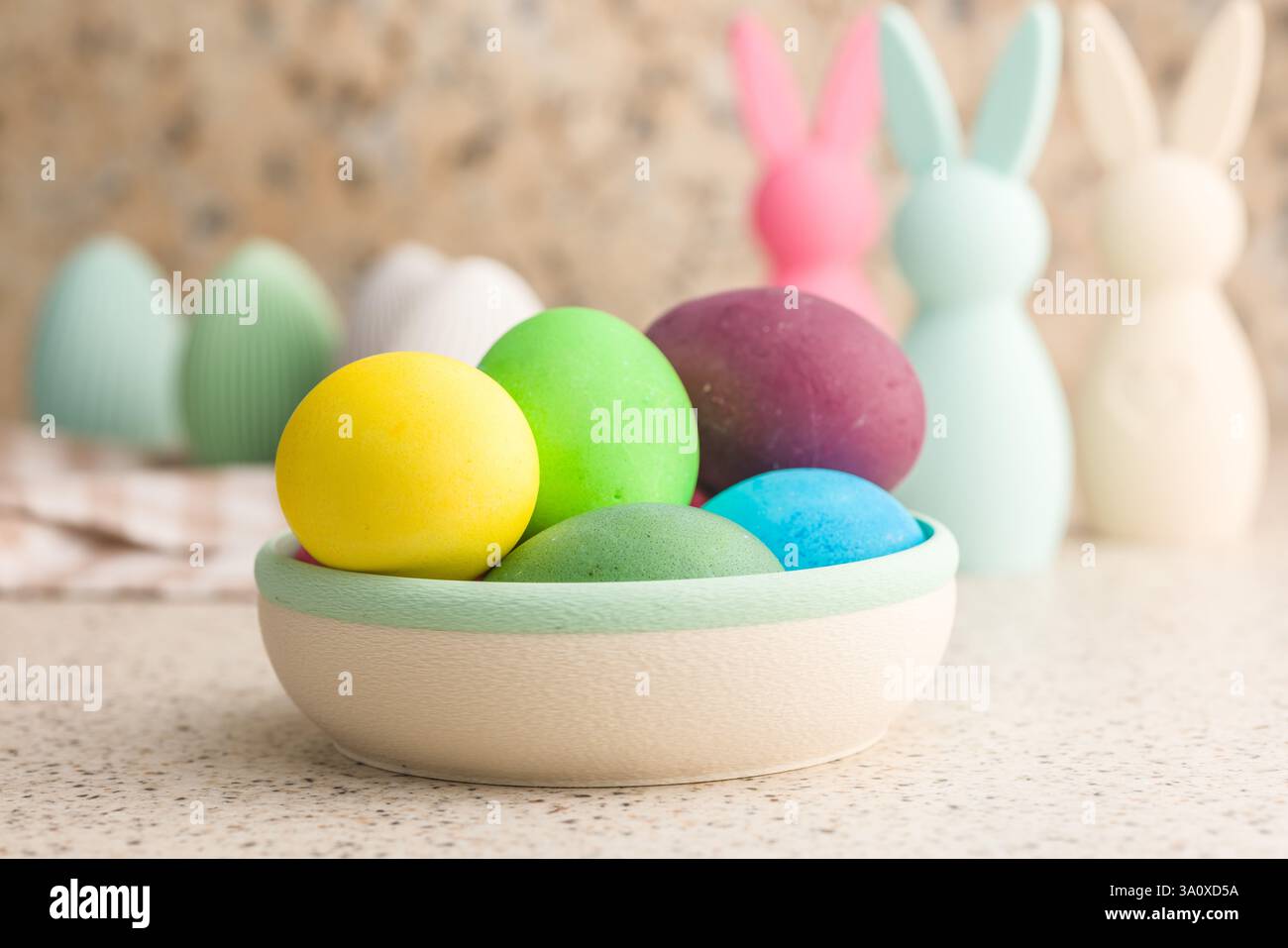 Easter decoration. Colorful eggs on kitchen table. Stock Photo
