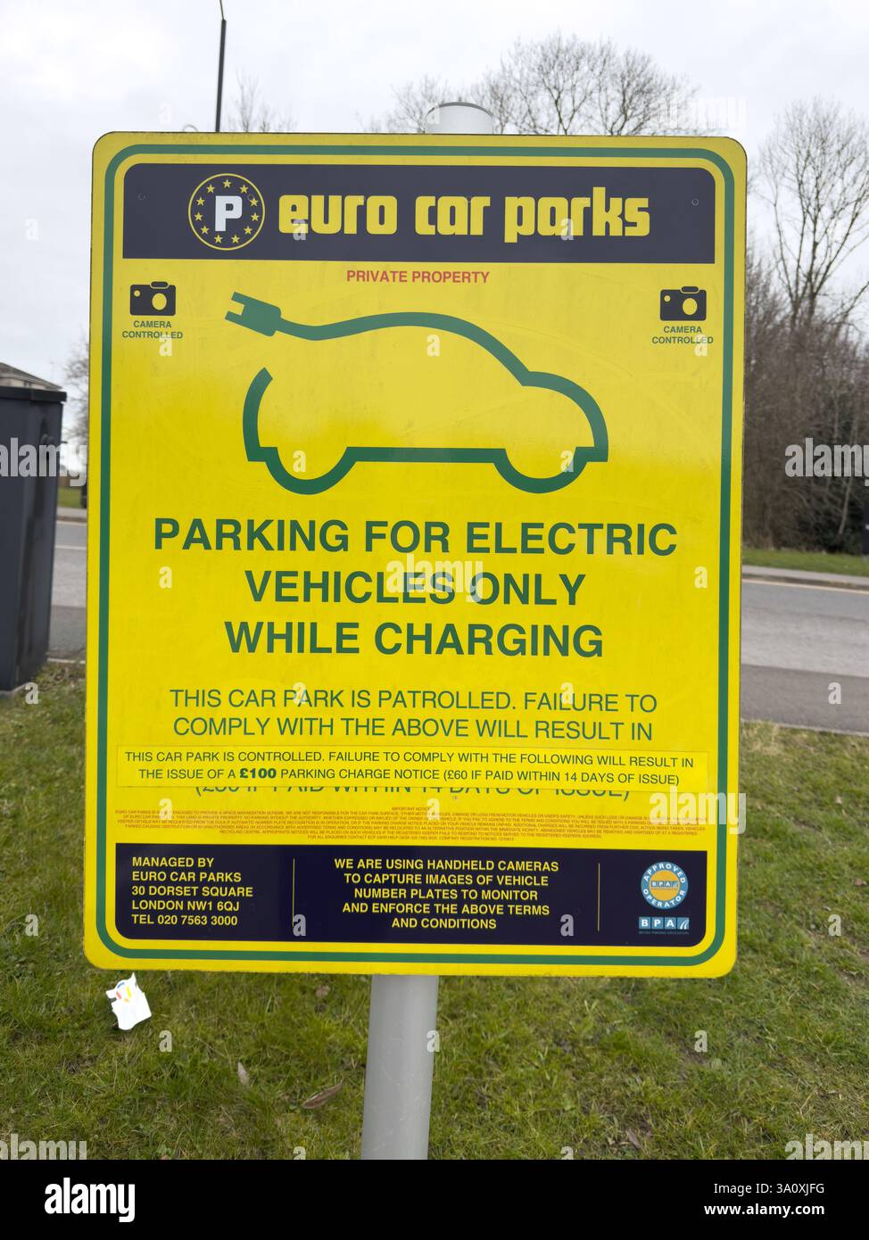 An electric car charger sign in a public car park - Smartphone Captured Stock Image