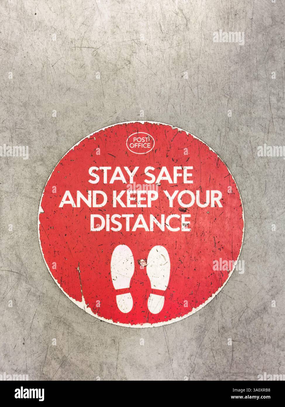 Keep Your Distance Covid sign in Post Office - Smartphone Captured Stock Image