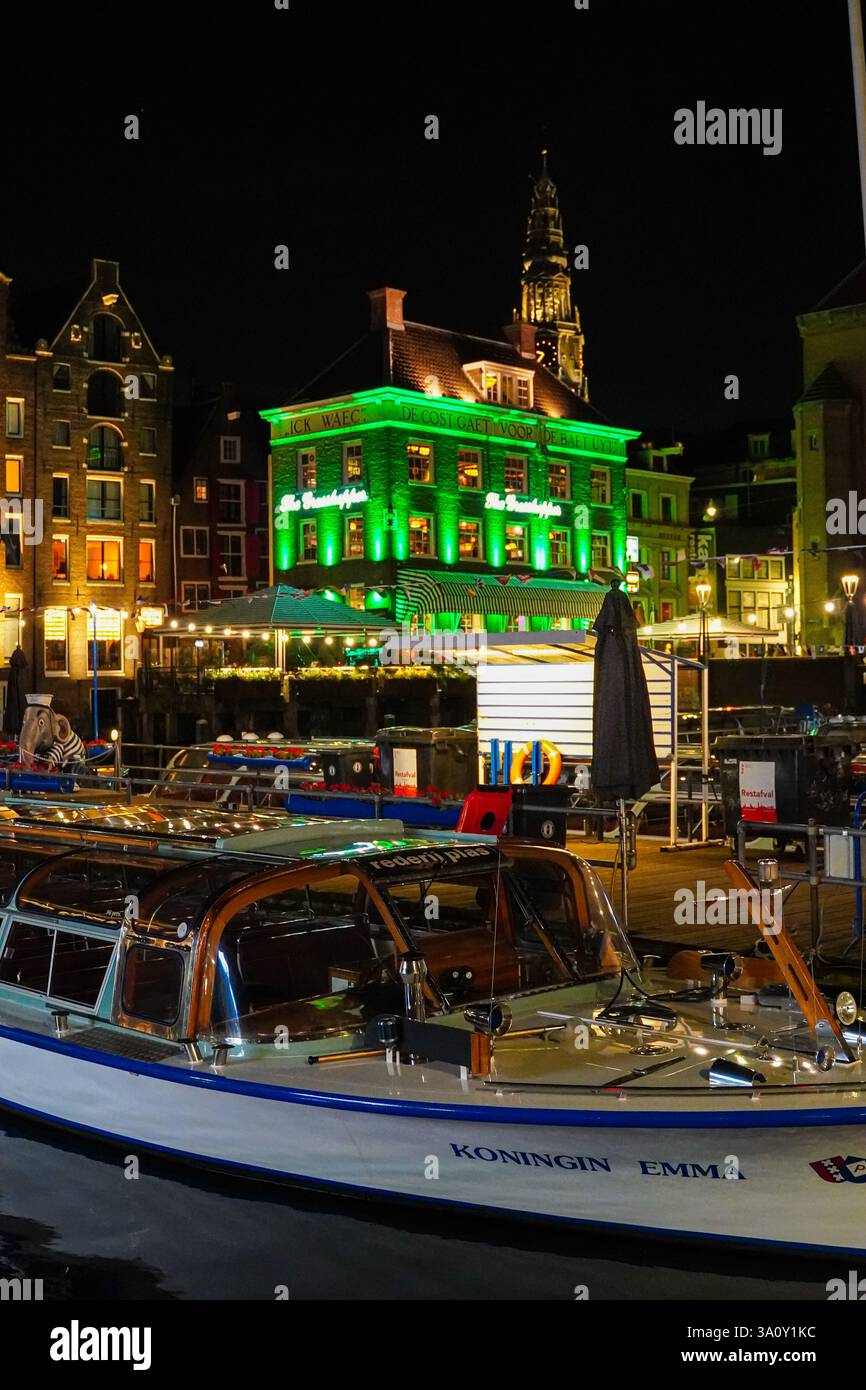 This aerial view of Amsterdam, Netherlands showcases its iconic canal houses, Dutch architecture, and boat tours along the waterfront, capturing the c Stock Photo