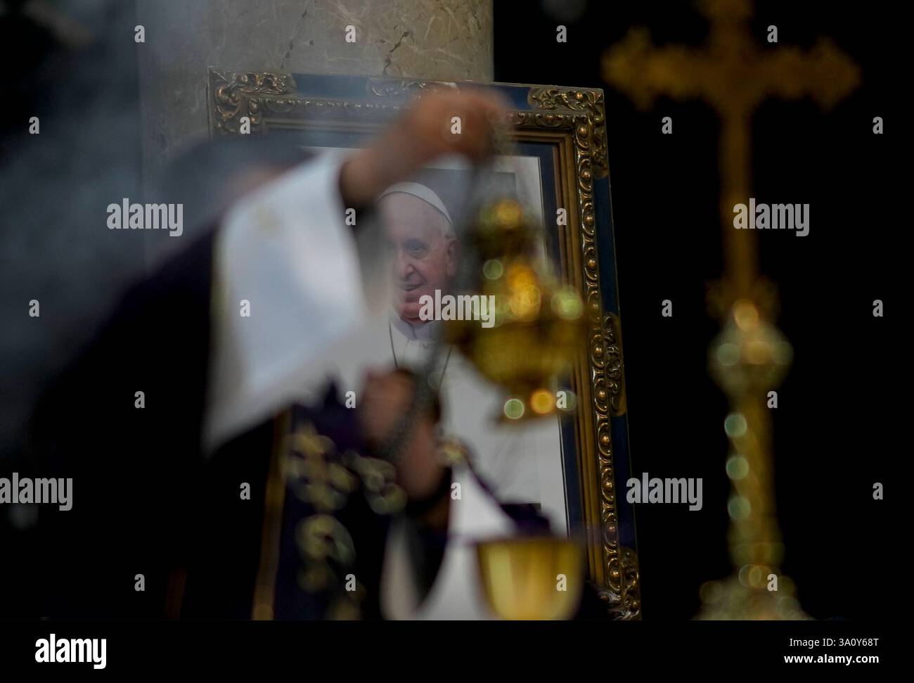 A priest leads an Ash Wednesday Mass in front of a photo of Pope ...
