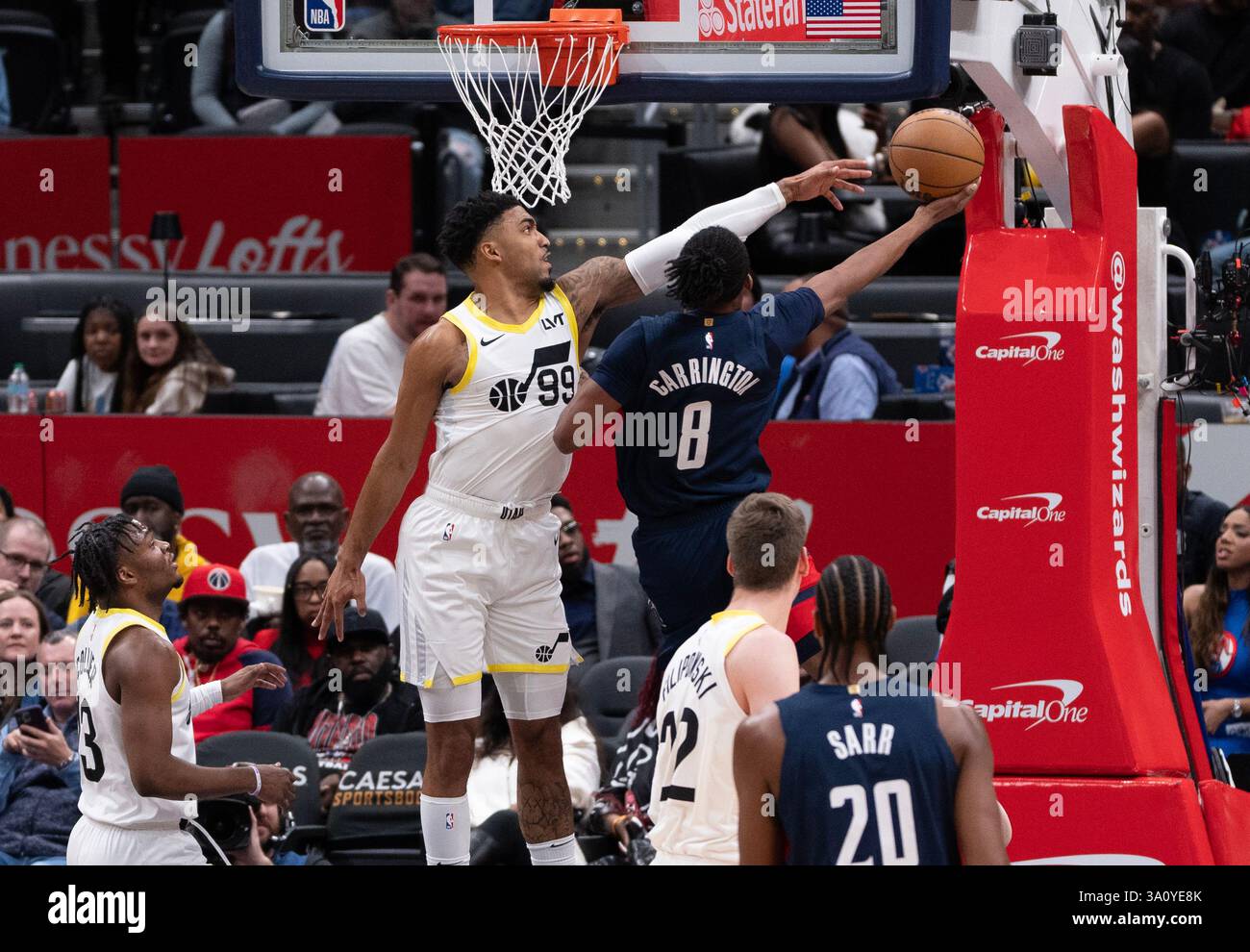 Washington, USA. 05th Mar, 2025. WASHINGTON, DC - MARCH 05: Utah Jazz forward KJ Martin (99) blocks a shot by Washington Wizards guard Bub Carrington (8) during a NBA game between the Washington Wizards and the Utah Jazz, on March 05, 2025, at Capital One Arena, in Washington, DC. (Photo by Tony Quinn/SipaUSA) Credit: Sipa USA/Alamy Live News Stock Photo