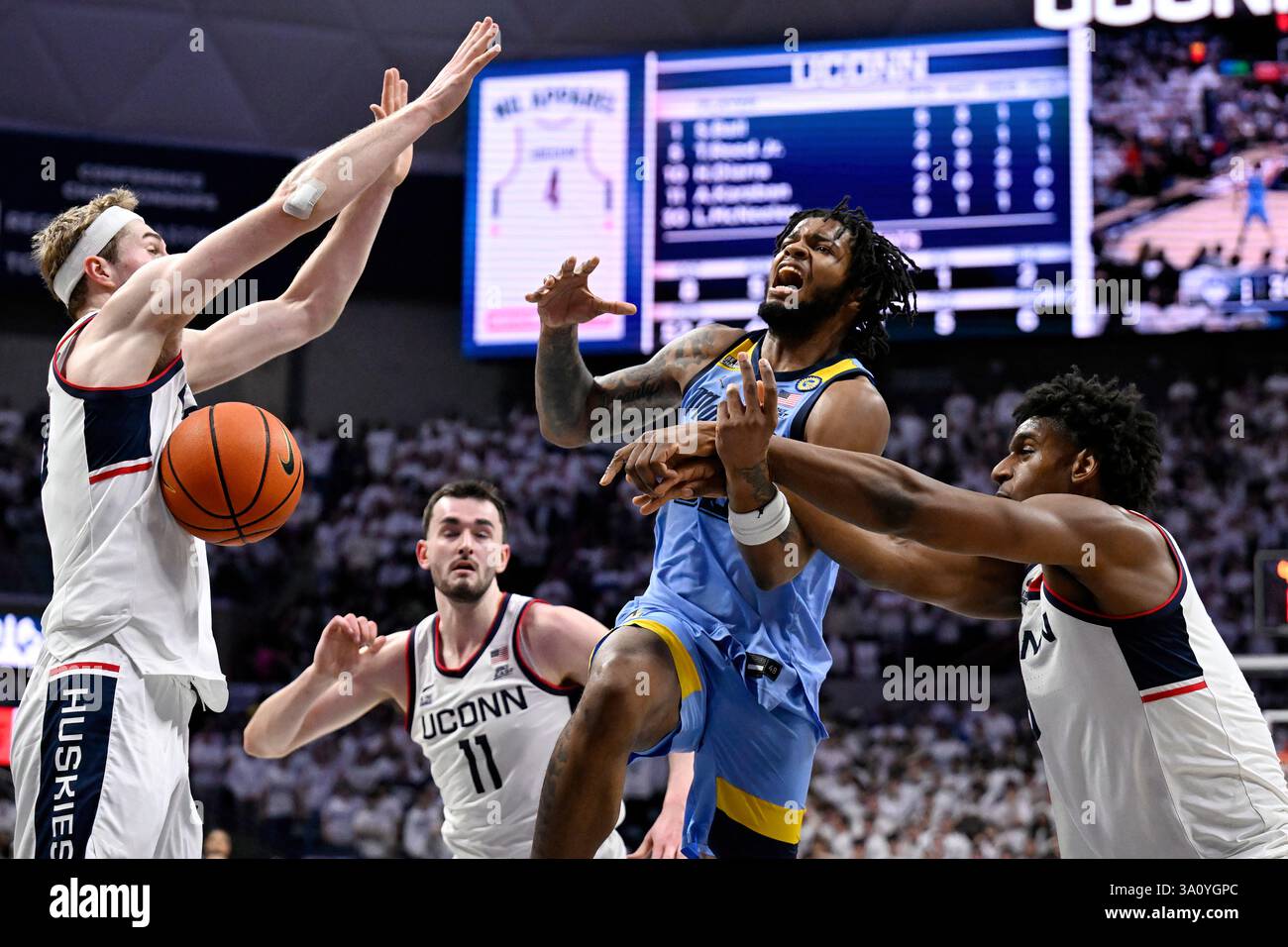 Marquette forward David Joplin, center, is fouled by UConn center ...