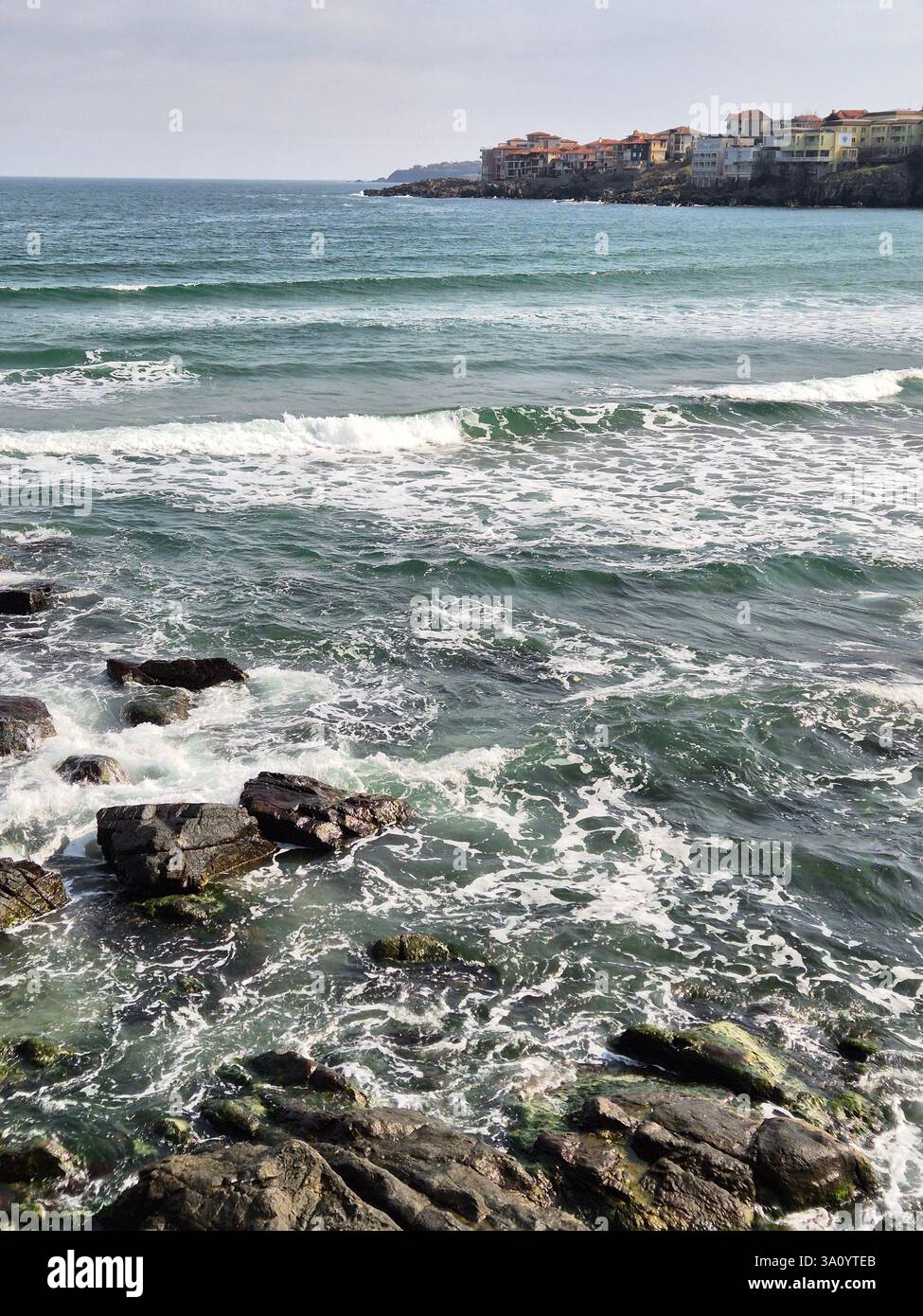 seashore. raging waves. cold sea. waves sometimes hit rocks - Smartphone Captured Stock Image