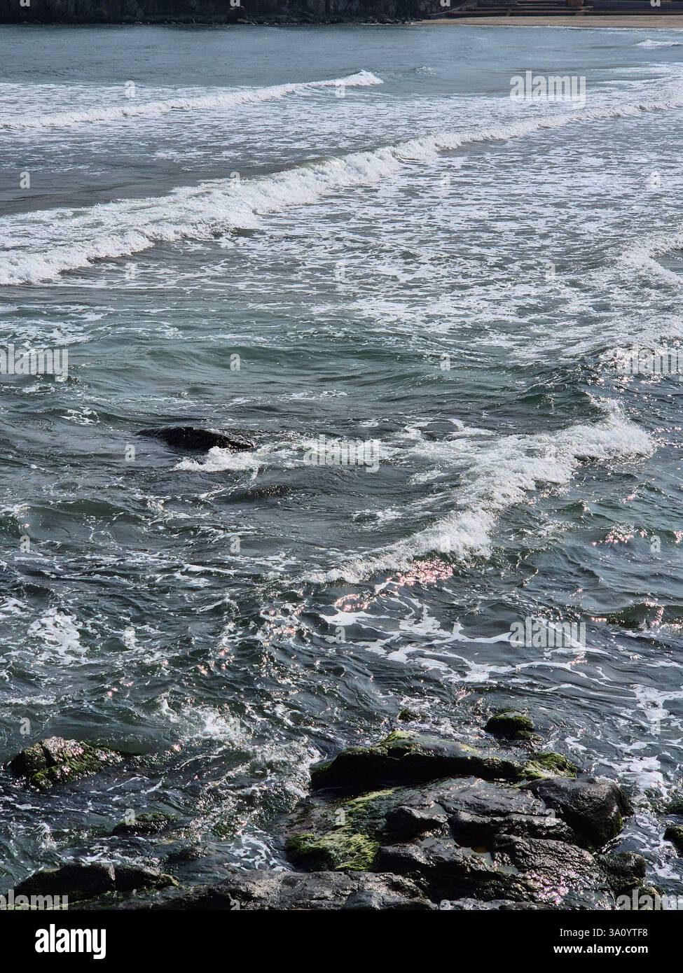 seashore. raging waves. cold sea. waves sometimes hit rocks - Smartphone Captured Stock Image