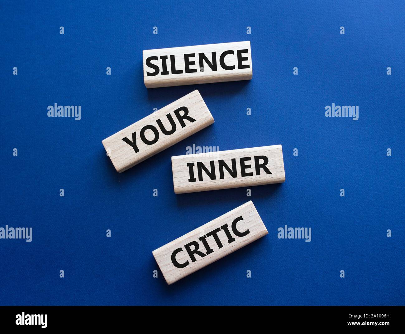 View of Silence your inner critic symbol. Wooden blocks with words Silence your ...