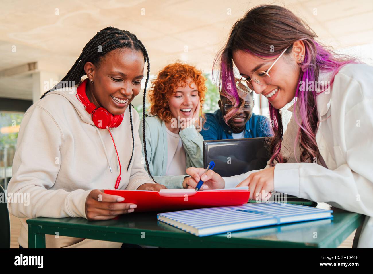 Excited diverse students engaged in collaborative learning while ...