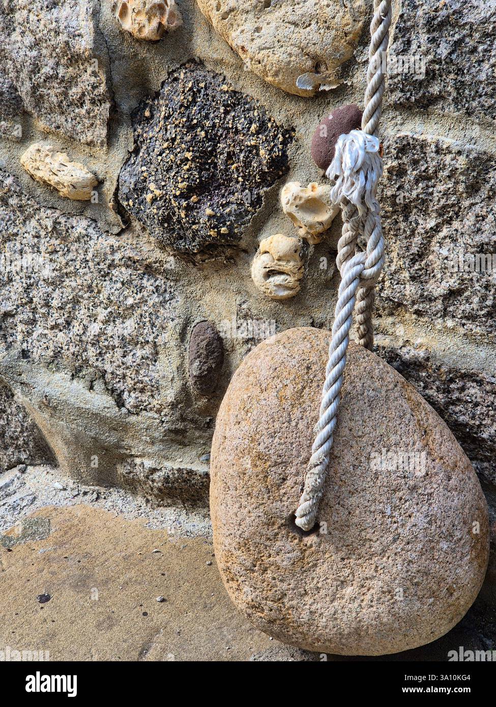A simple yet beautiful object. Stone and rope - Smartphone Captured Stock Image