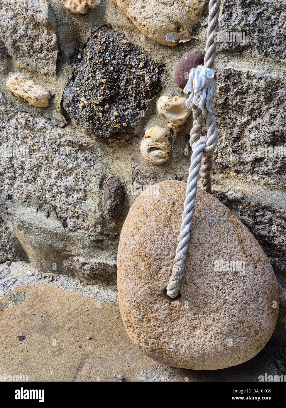 A simple yet beautiful object. Stone and rope - Smartphone Captured Stock Image