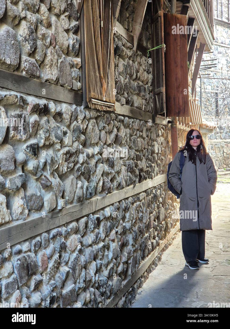 young woman standing near the wall - Smartphone Captured Stock Image