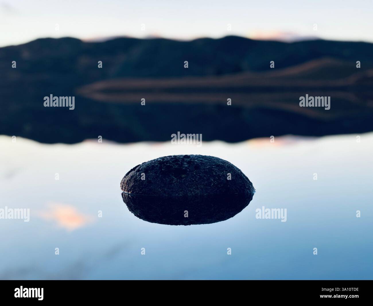 Rock in still water - Smartphone Captured Stock Image