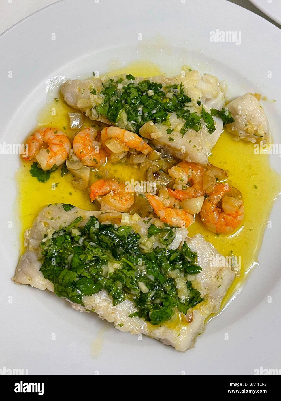Hake loins with prawns and spinach. - Smartphone Captured Stock Image