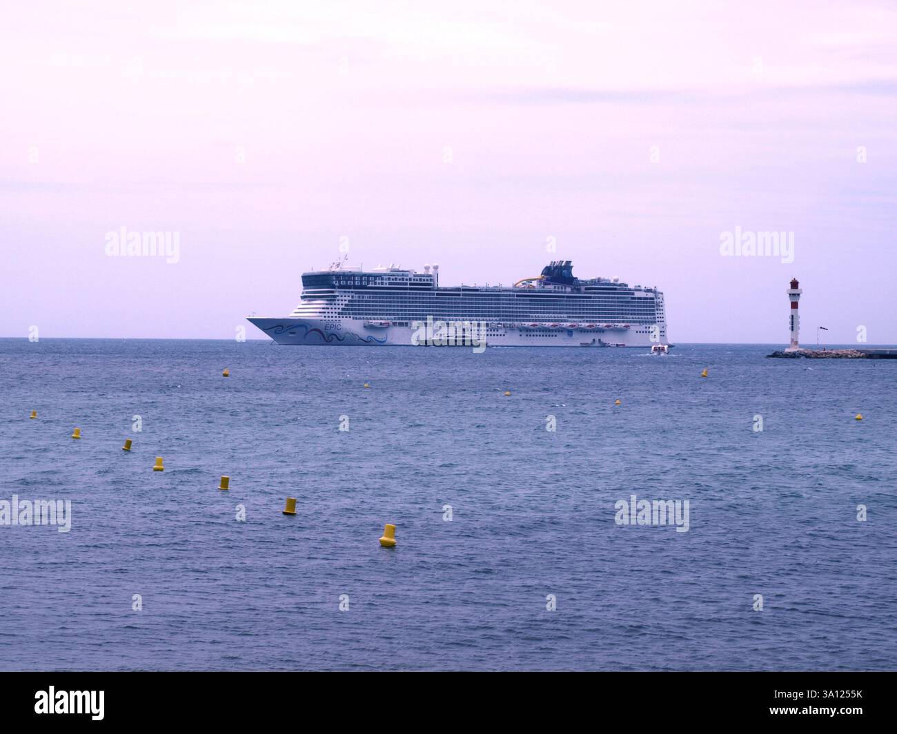 The Norwegian Epic full with vacationers stopping not far from the shore of Cannes. Stock Photo