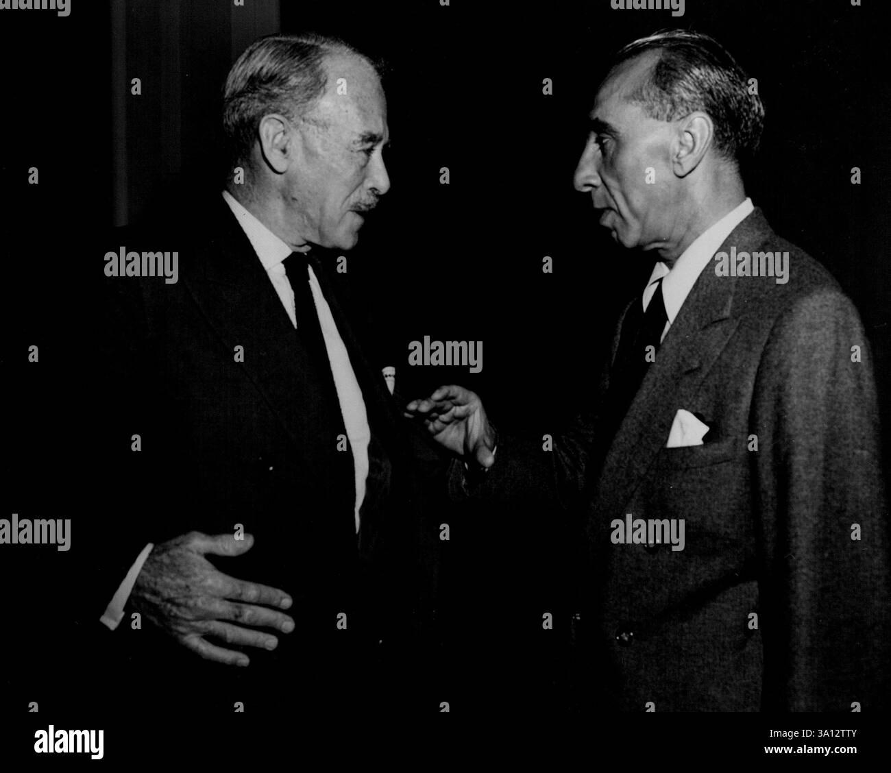 10th Session Of The U.N. General Assembly -- Mr. Ahmed S. Bokhari (right), Under-Secretary of the U.N. for Public Information, talking with Mr. R.G. Casey, Australia's Minister of State for External Affairs, before a meeting of the Tenth session of the United Nations General Assembly. September 20, 1954. (Photo by United Nations). Stock Photo