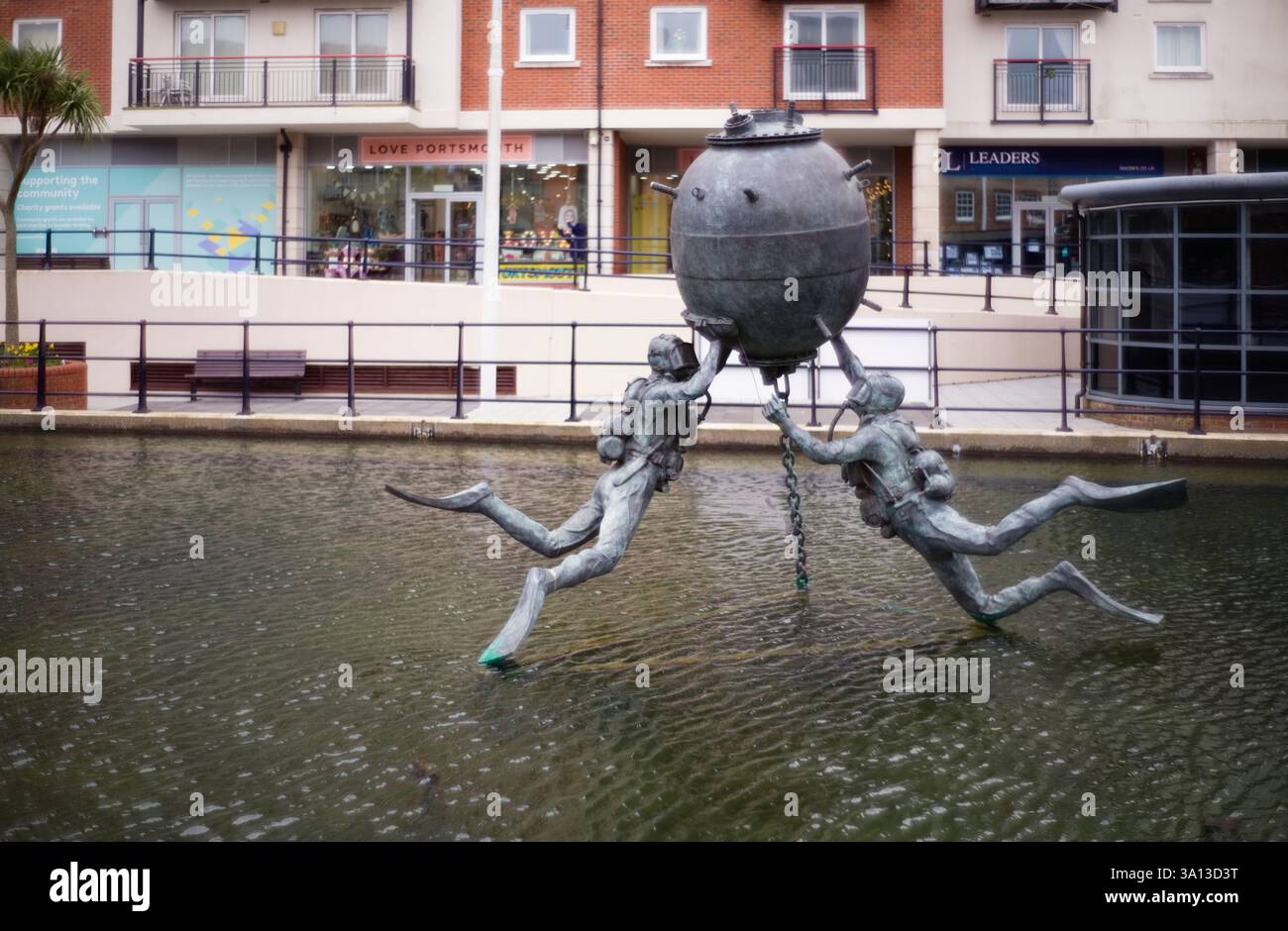 Sculpture in Gunwharf Quays, by Mark Richards shows how divers would work on a sea mine Stock Photo