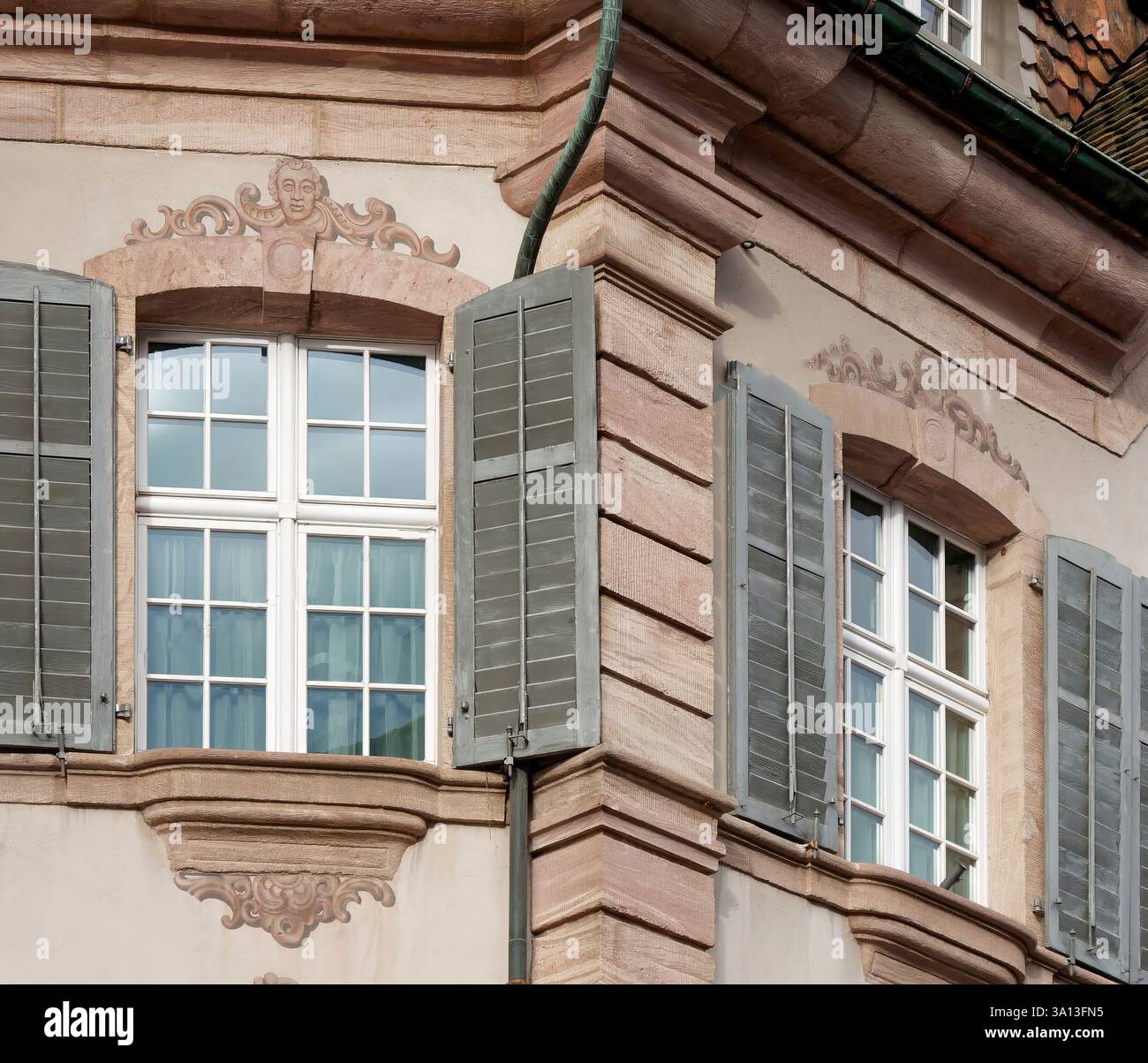 Elegant Historic Building Facade With Shuttered Windows and Architectural Details Stock Photo