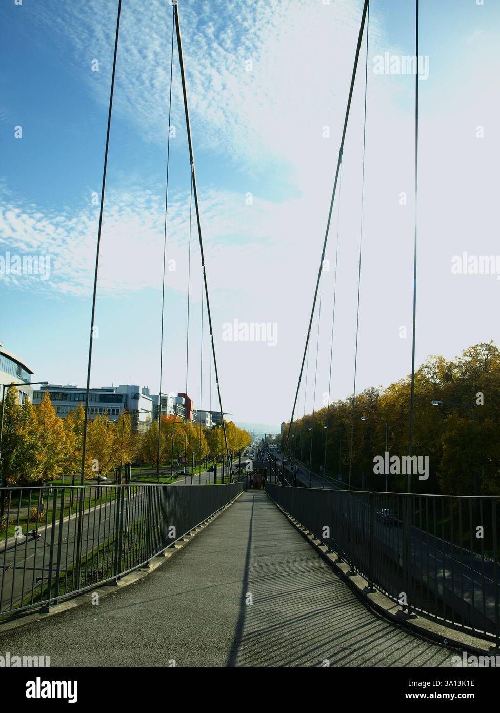 A foot bridge and its depth on a sunny autumn  sky. Stock Photo