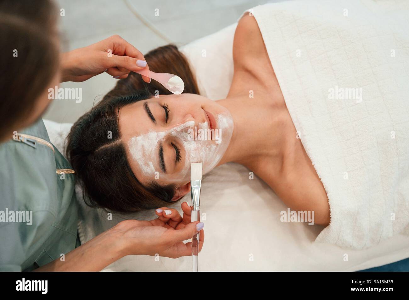 Beautician taking off facial mask hi-res stock photography and images ...