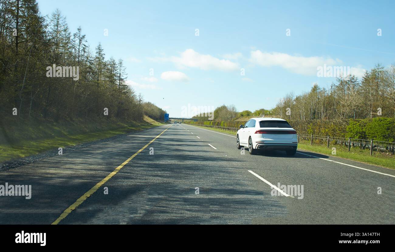 Rear view of cars driving on motorway, Ireland. Road with metal safety ...