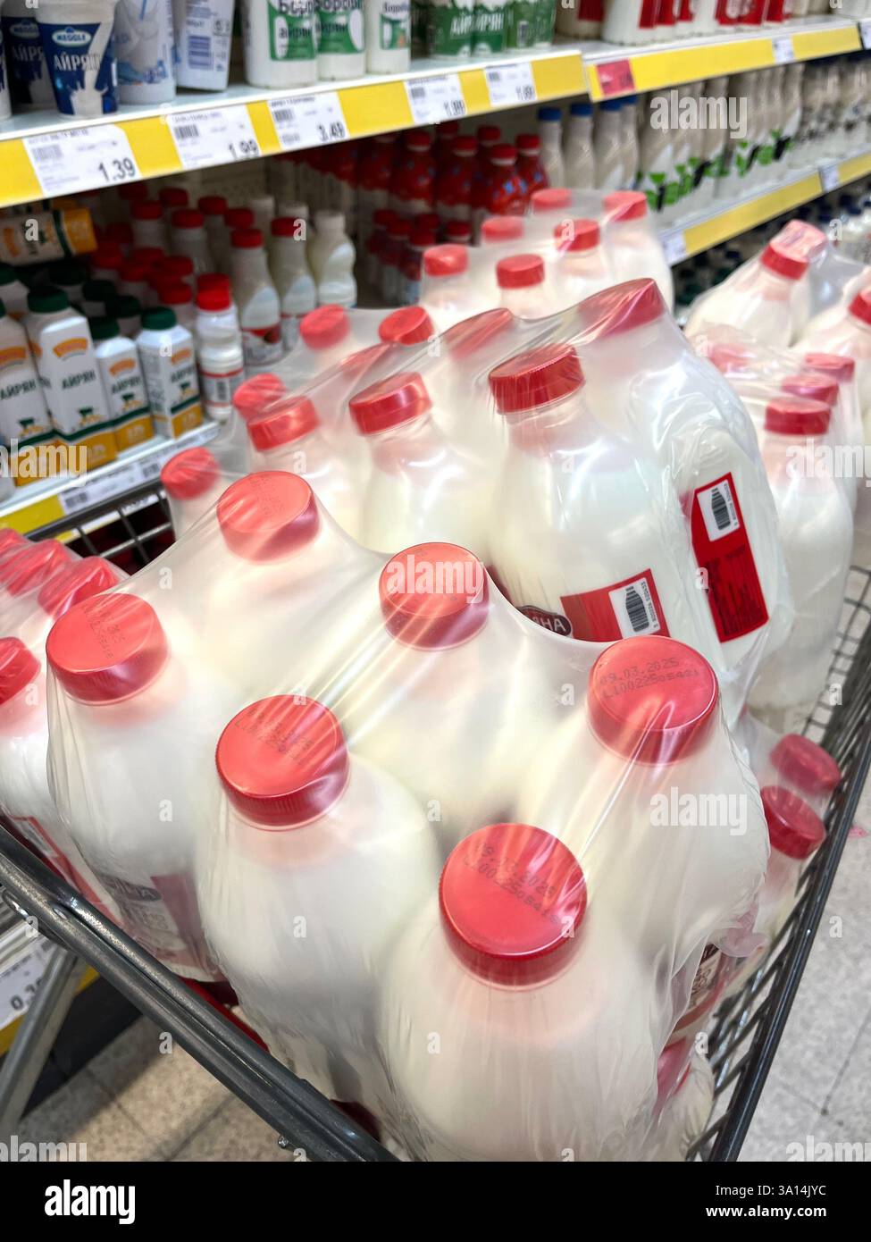 milk aisle, shopping, consumerism, supermarket, superstore, supermarket shelf, grocery store, bottled milk, milk, shopping trolley, shopping cart - Smartphone Captured Stock Image